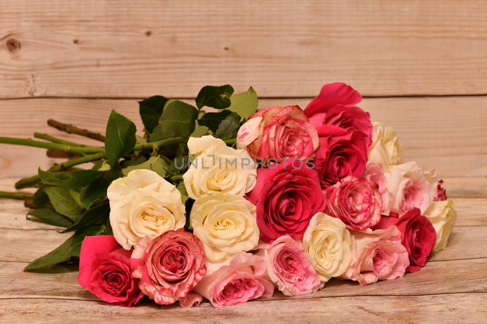 bouquet of yellow and pink roses lies on the table