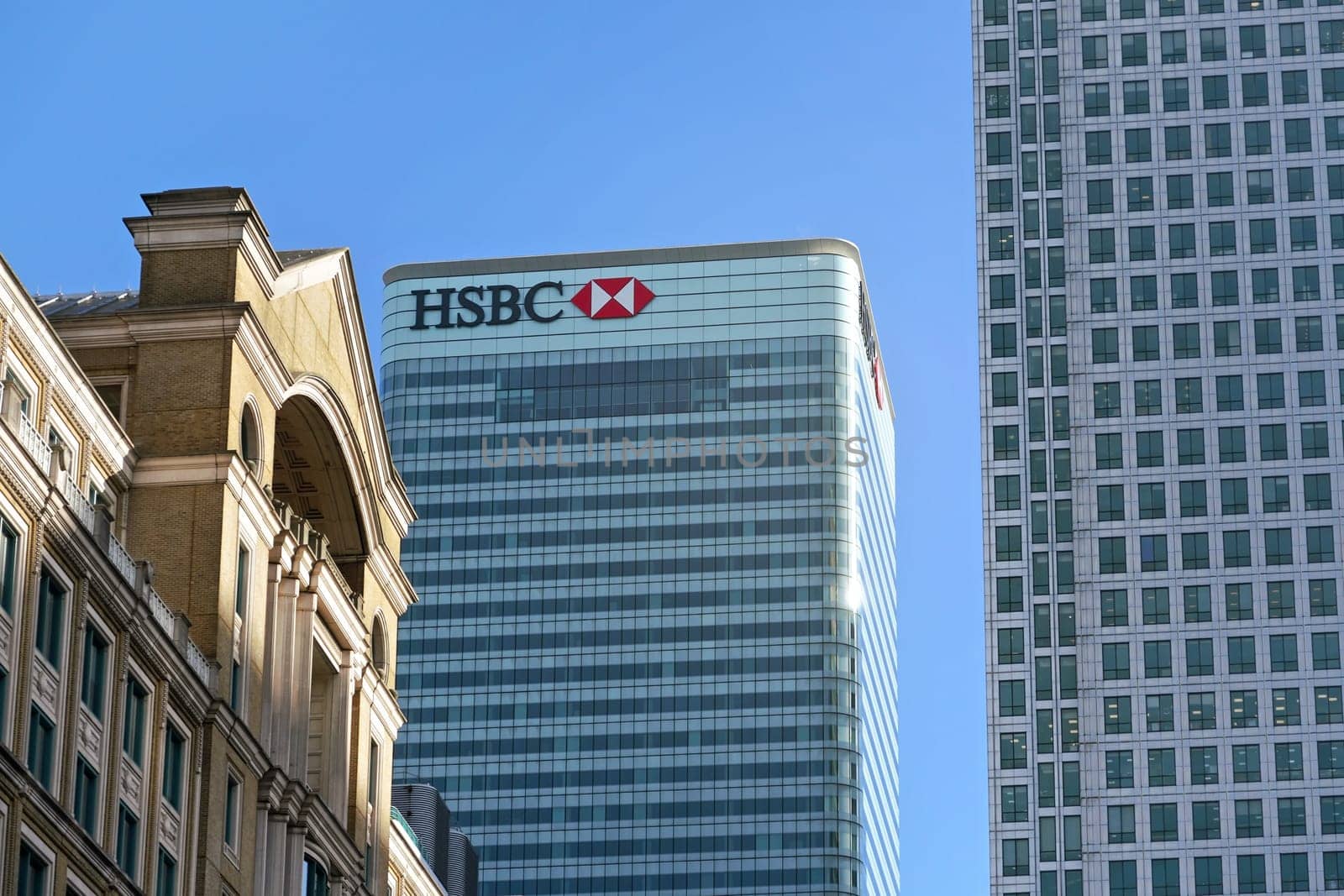 London, United Kingdom - February 03, 2019: Sun shines on world Headquarters of HSBC Holdings plc at 8 Canada Square, Canary Wharf. It is 7th largest bank worldwide, was established in 1865