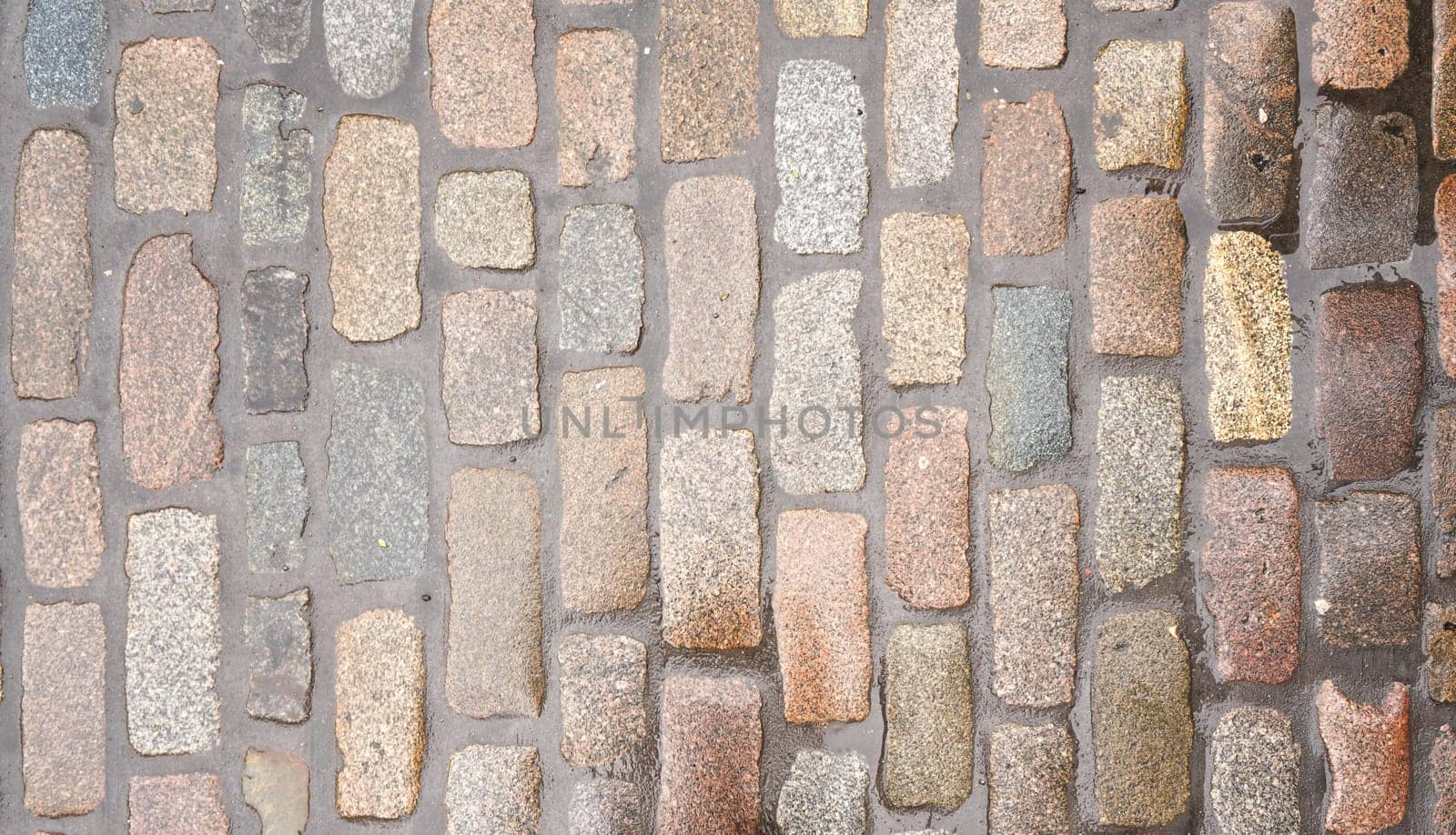 Wet cobblestone or brick stone road, view from above, can be used as texture by Ivanko