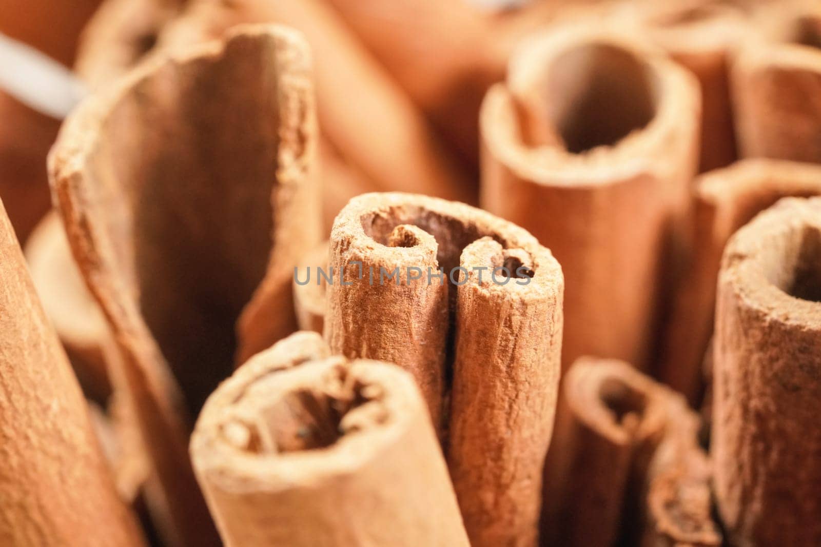 Closeup detail - Heap of cinnamon bark sticks by Ivanko
