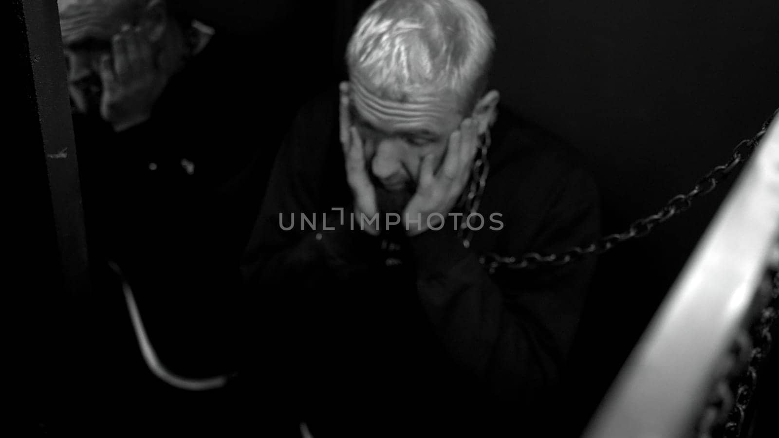 Drunk man in night club with metal chain around his neck needs help. Media. Concept of alcohol and drug abuse. by Mediawhalestock