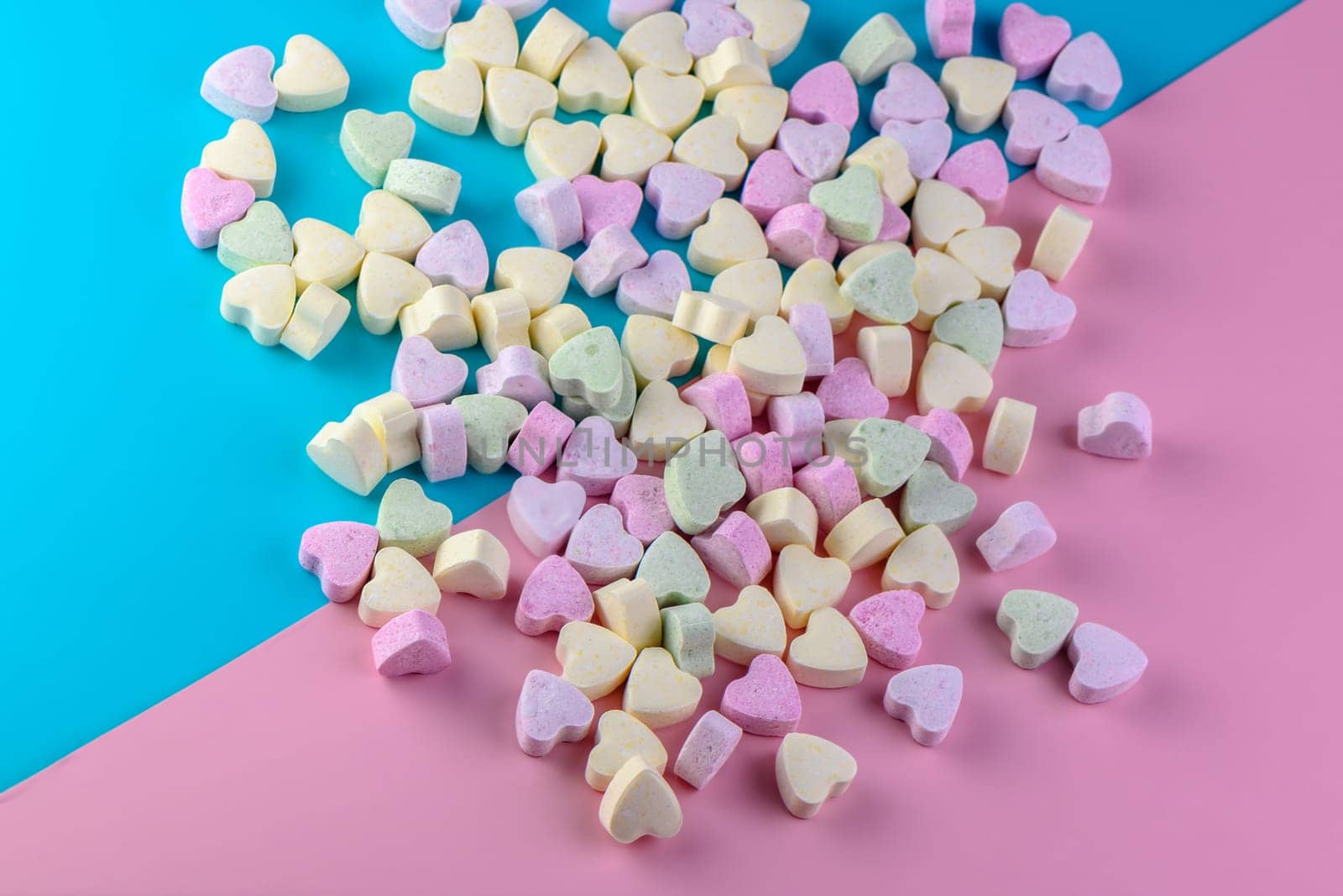 candies in the shape of a heart on a red and blue background