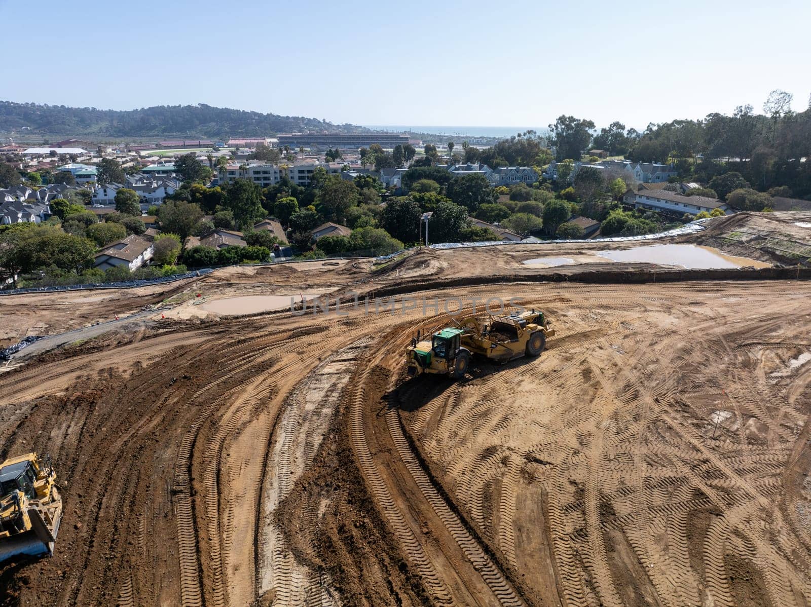 Aerial view of heavy construction equipment working at the construction site. San Diego, California, March, 10th, 2024