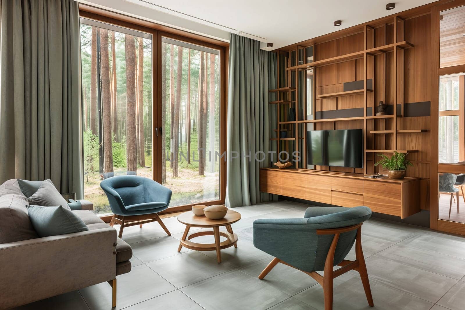 A living room in a house with furniture including a couch, chairs, table, and television. The interior design features wood floors and a large window