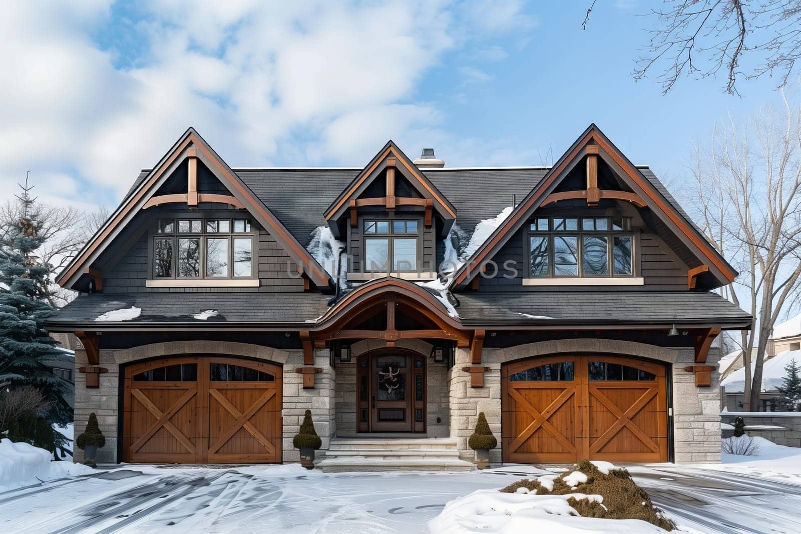 A large house with three garage doors sits covered in snow under a cloudy sky, showcasing its beautiful facade and multiple windows