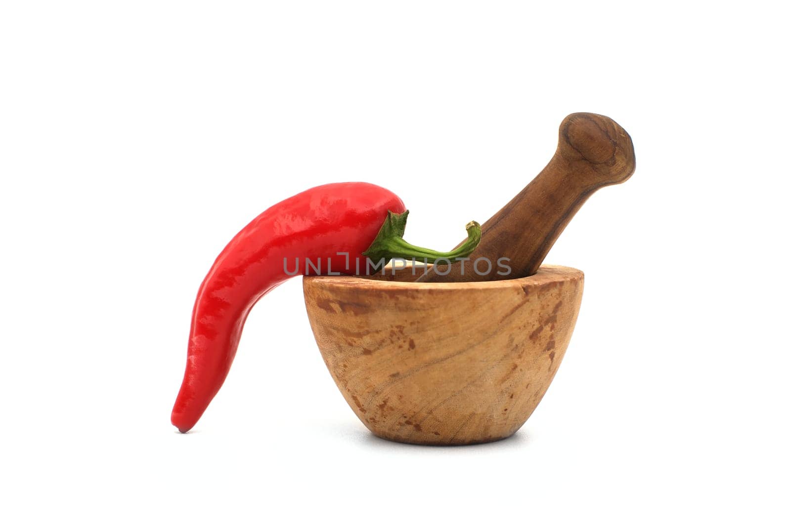 Fresh red chili pepper and old rustic wooden pestle with mortar isolated on a white background