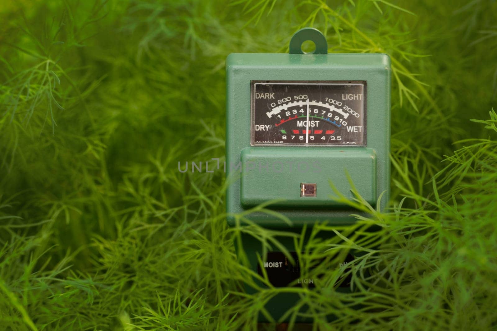 Green plants and three way meter PH, light and moisture in the soil. High technology agriculture concept