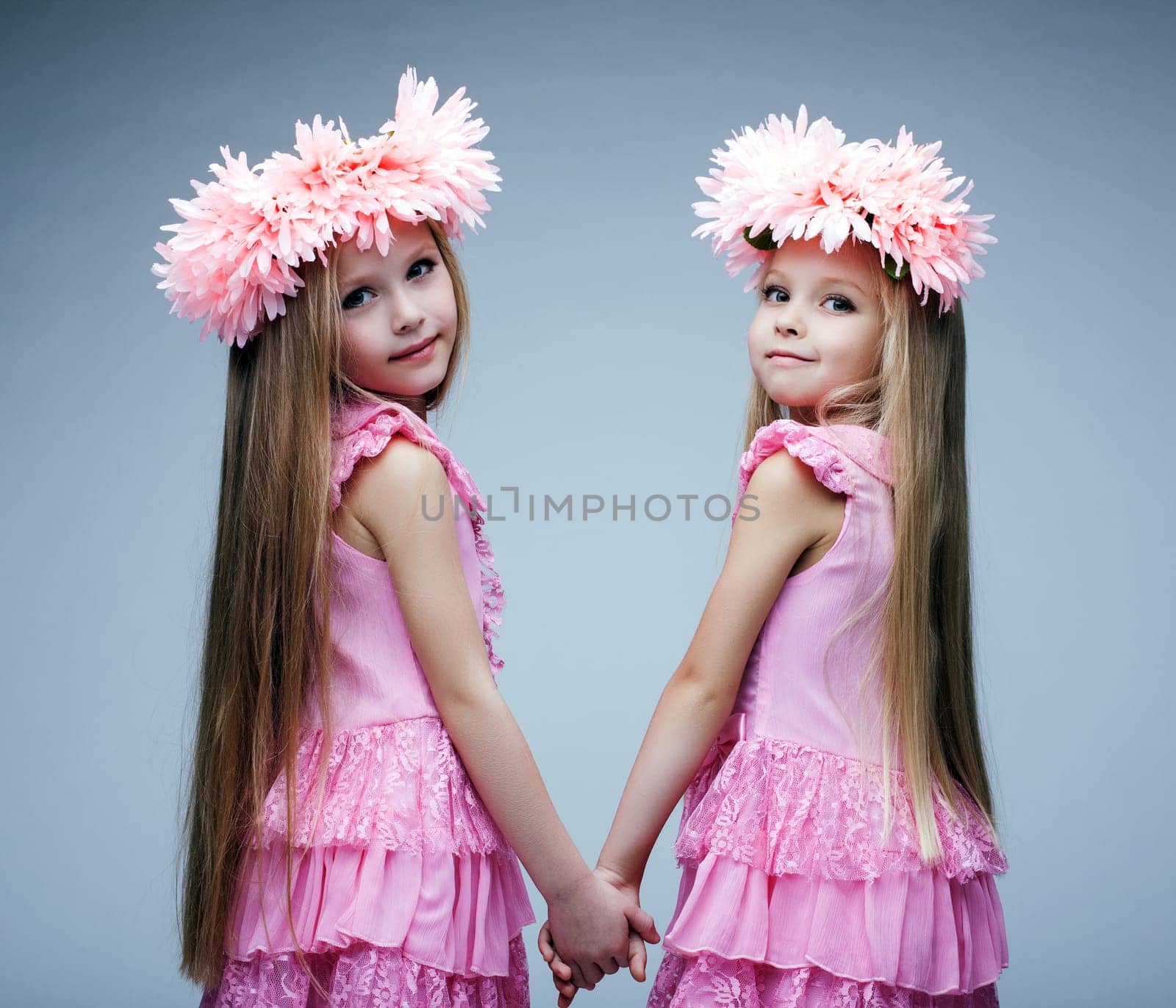 Glamour portrait of little girls in pink dresses