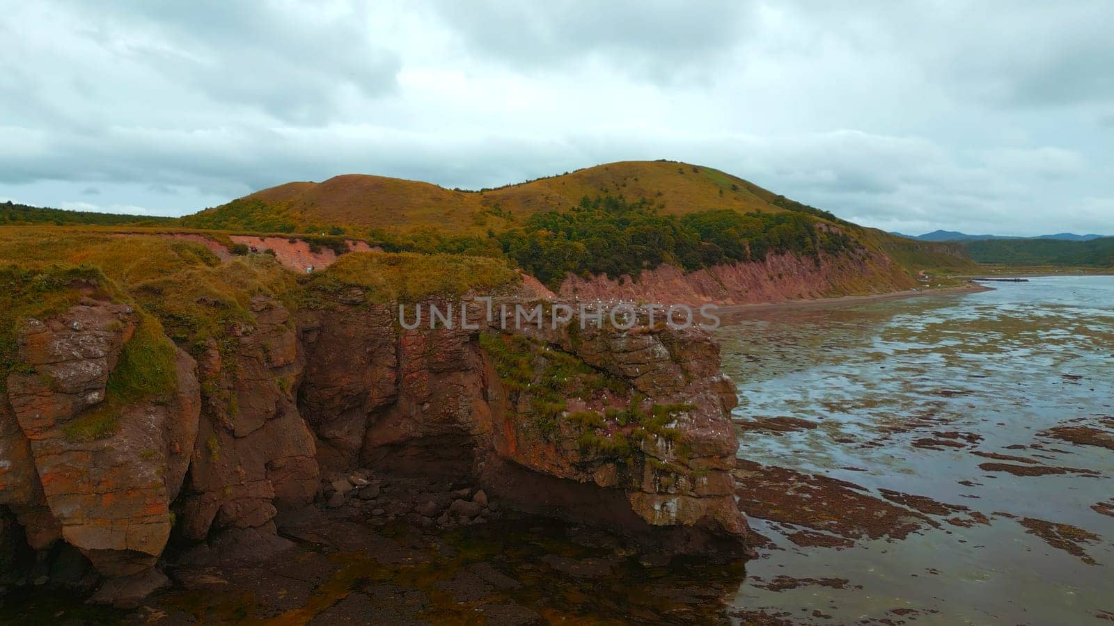 Rocky bay with swampy water. Clip. Amazing natural landscape with rocks in swampy sea bay. Rocky sea bay with algae.