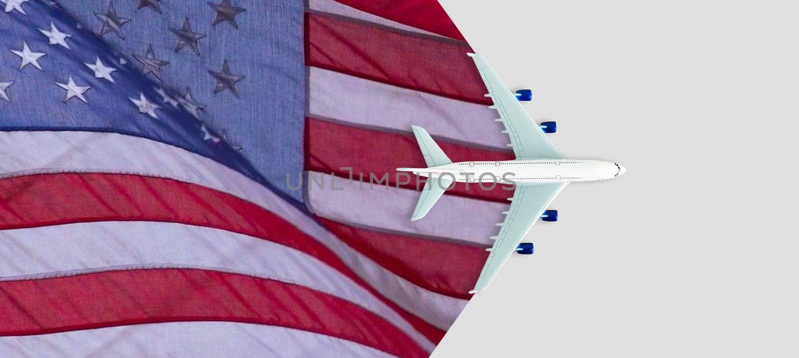 Toy plane with american flag on grey background. Top view