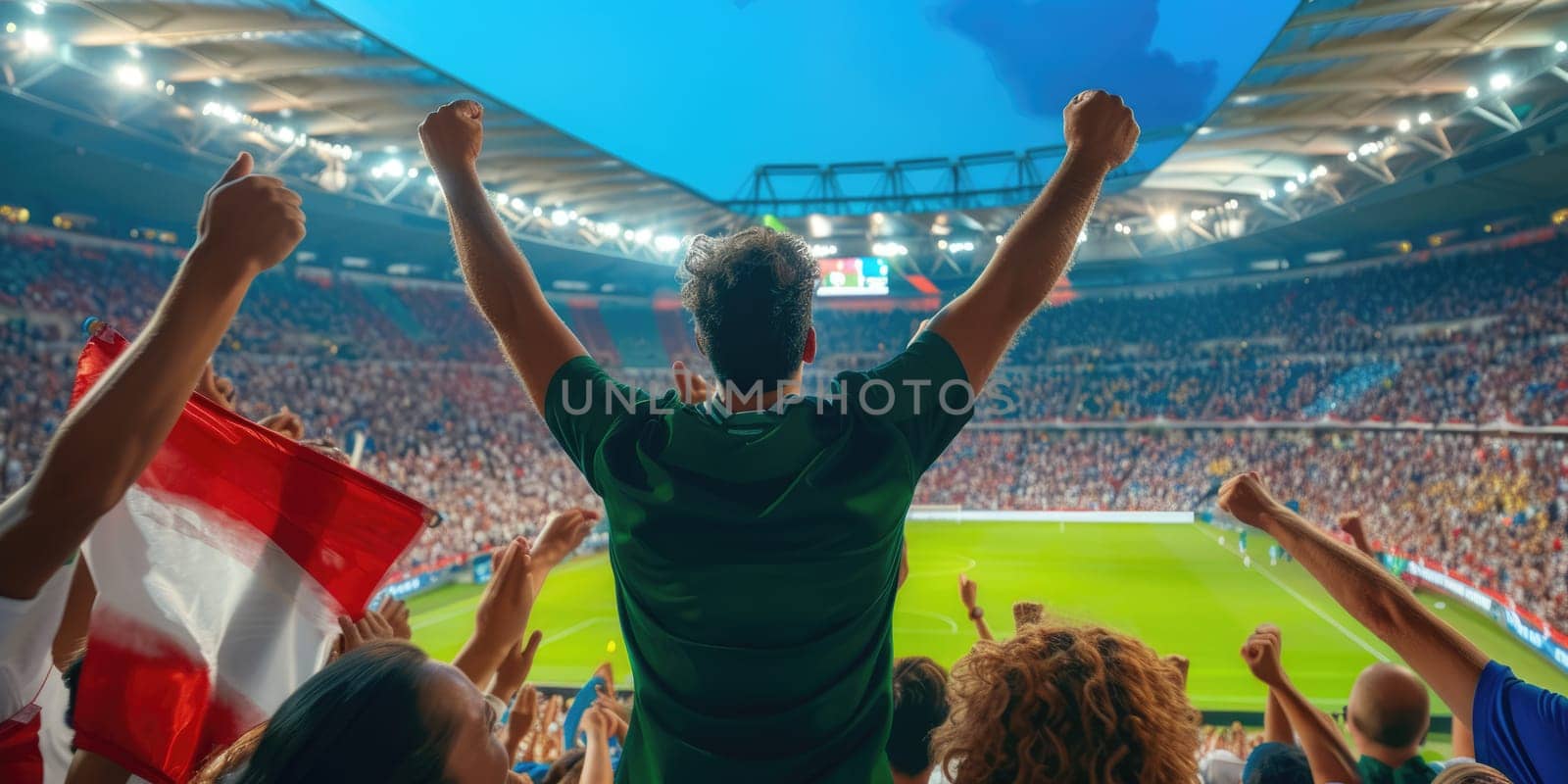 A man is watching a soccer game in a stadium with his arms in the air AIG41 by biancoblue