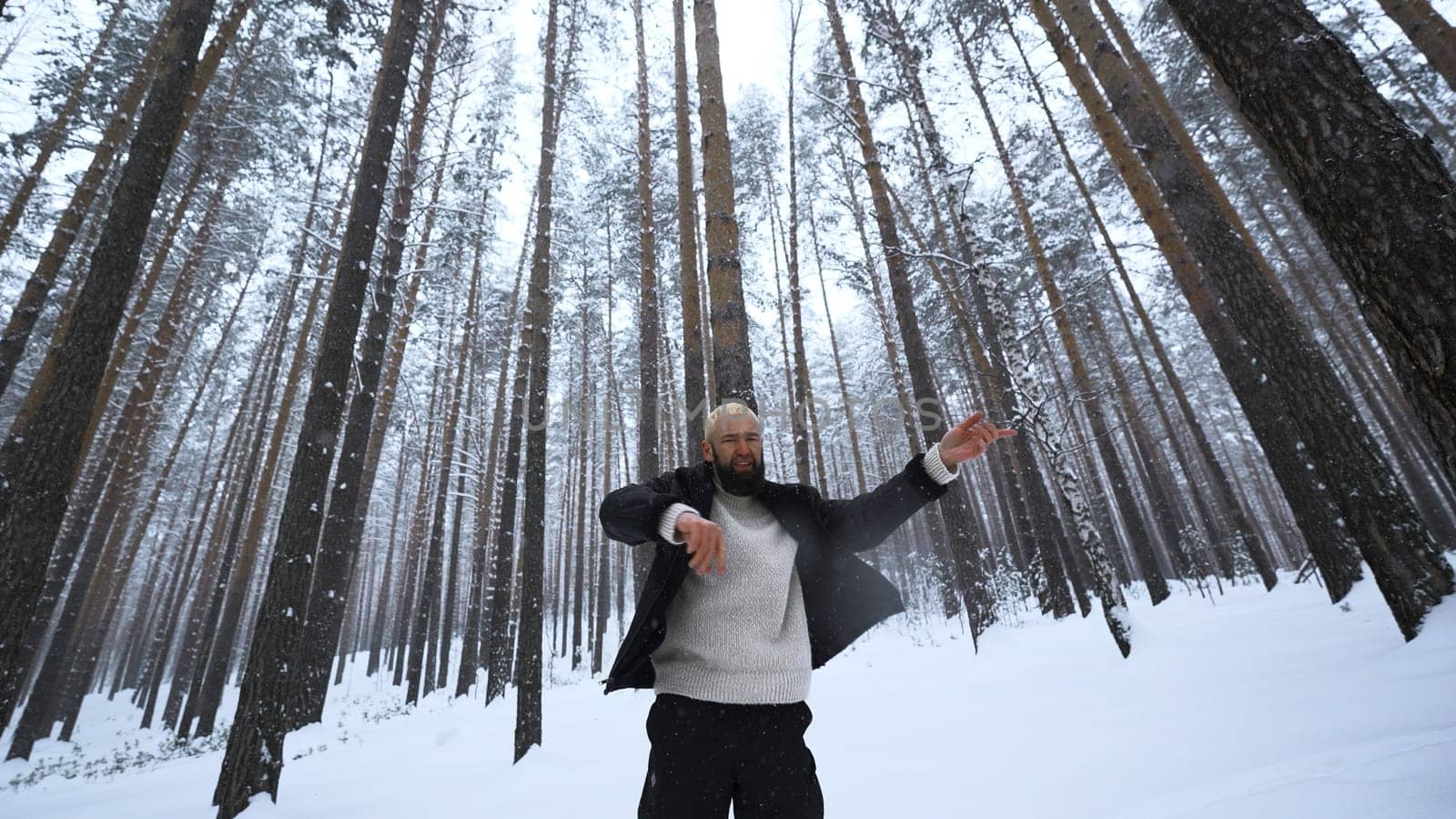 Man dancing in winter forest. Media. Stylish man filming video clip in winter forest. Shooting stylish man in winter forest by Mediawhalestock