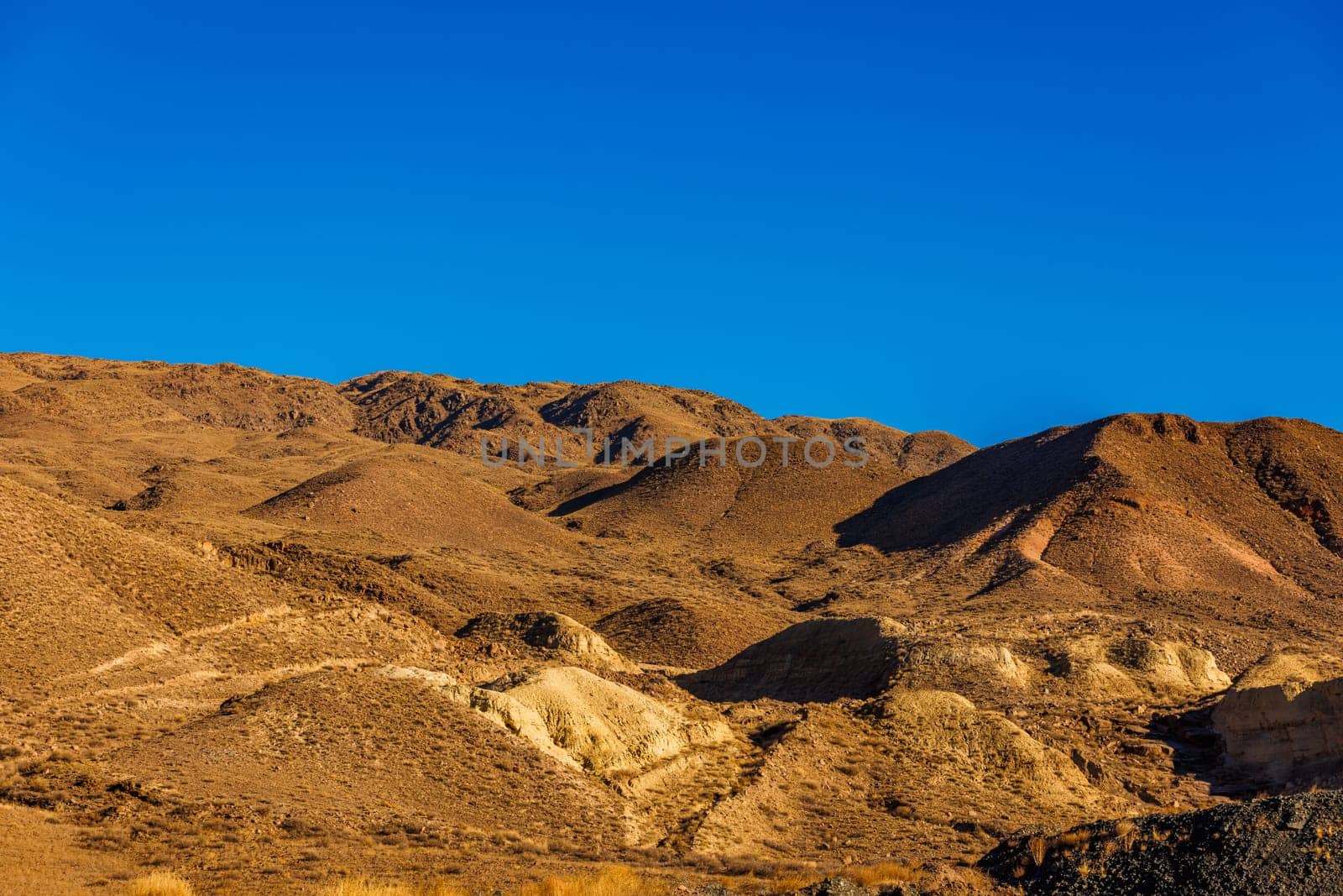 a mountain range with a blue sky in the background by z1b