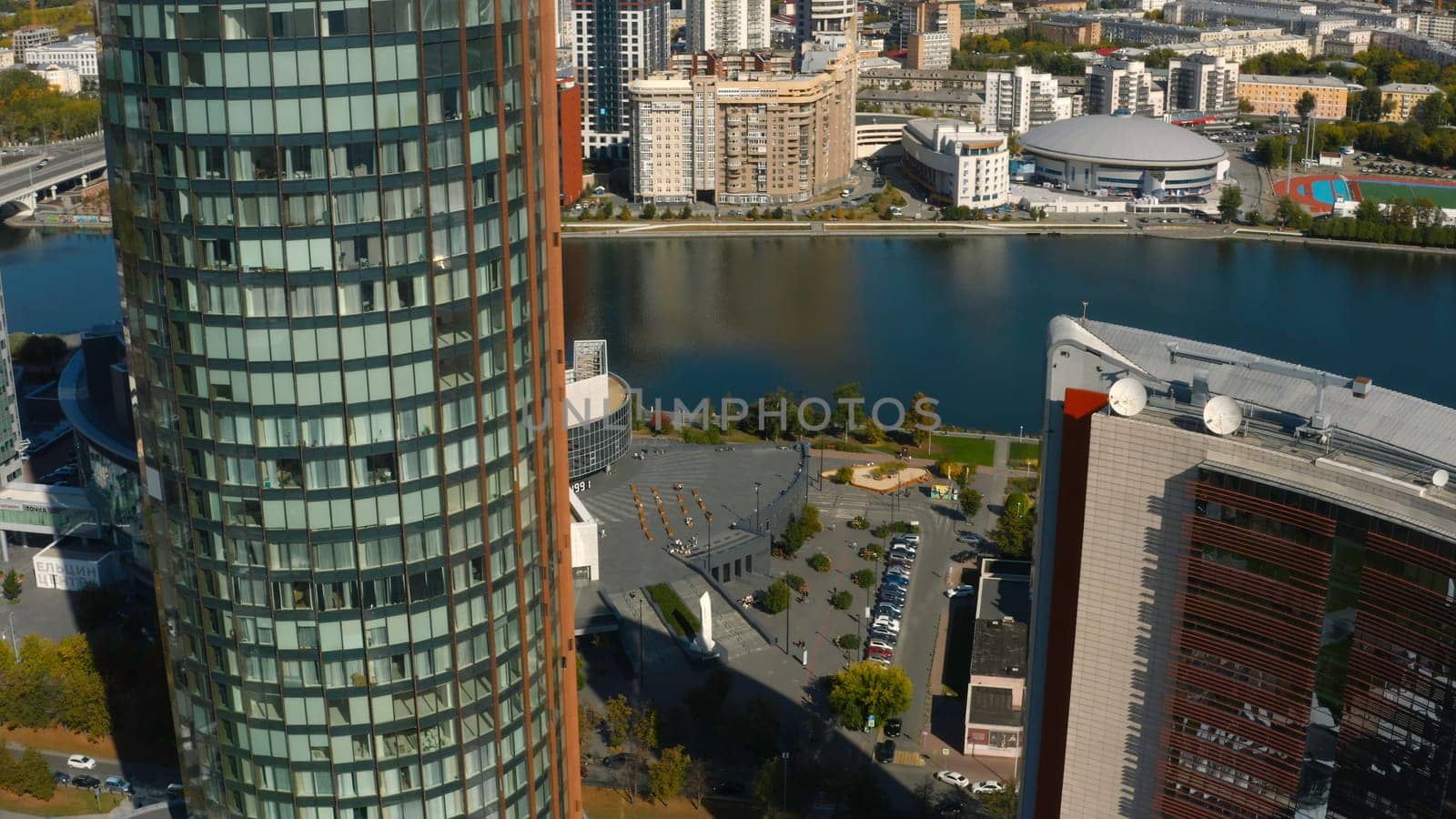 Beautiful architecture of modern high-rise buildings with offices. Stock footage. Business centers in high-rise buildings with glass facade in city center. Top view of beautiful architecture of modern city on sunny summer day.
