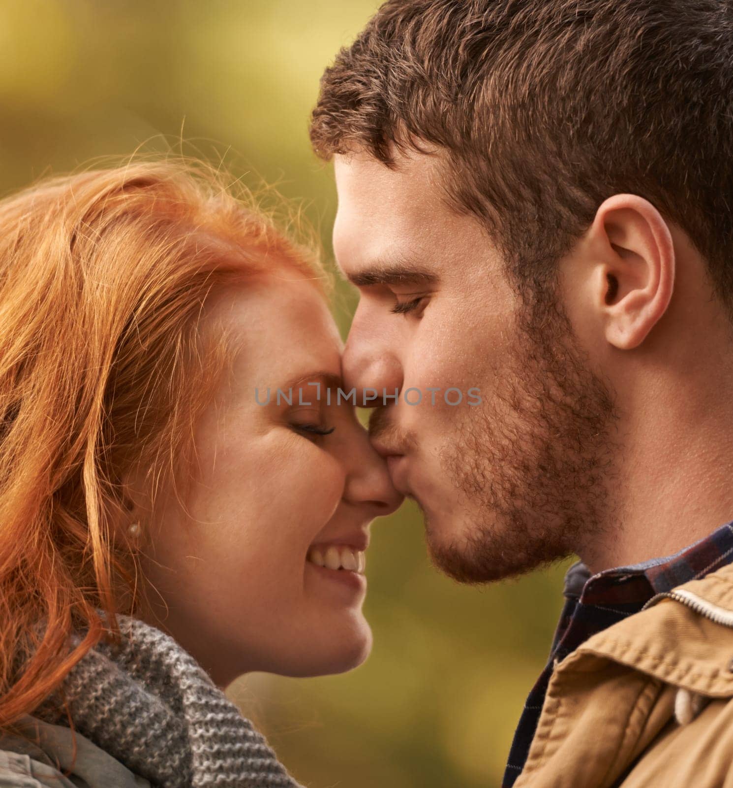 Date, kiss and couple closeup with love in park nature on holiday adventure or relax on vacation in woods. Together, man and woman with support and care in marriage and travel forest in morning by YuriArcurs