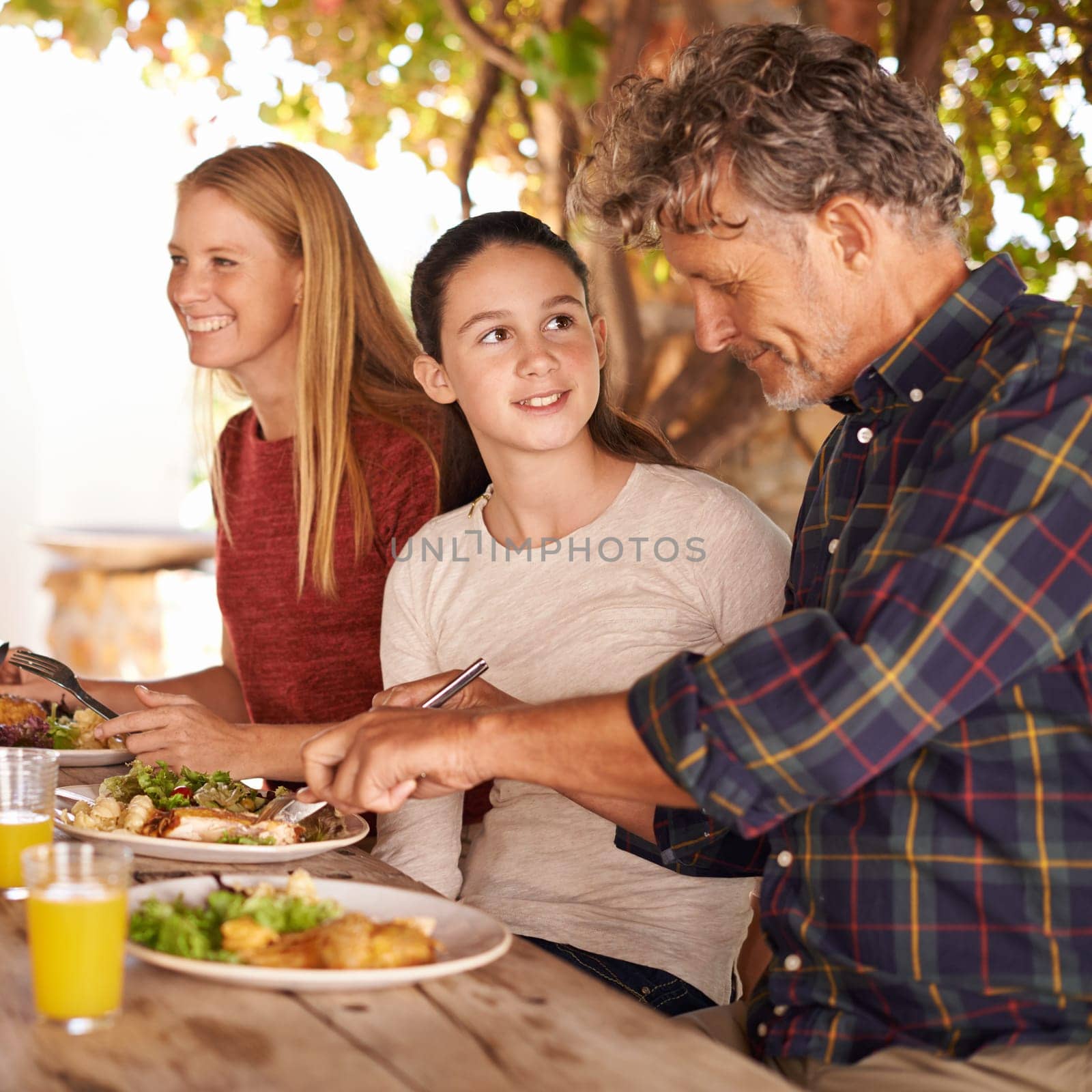 Family, outdoor and lunch with celebration, happiness and smile with social gathering and bonding together. Parents, group and mother with father and daughter with food and healthy meal with sunshine.