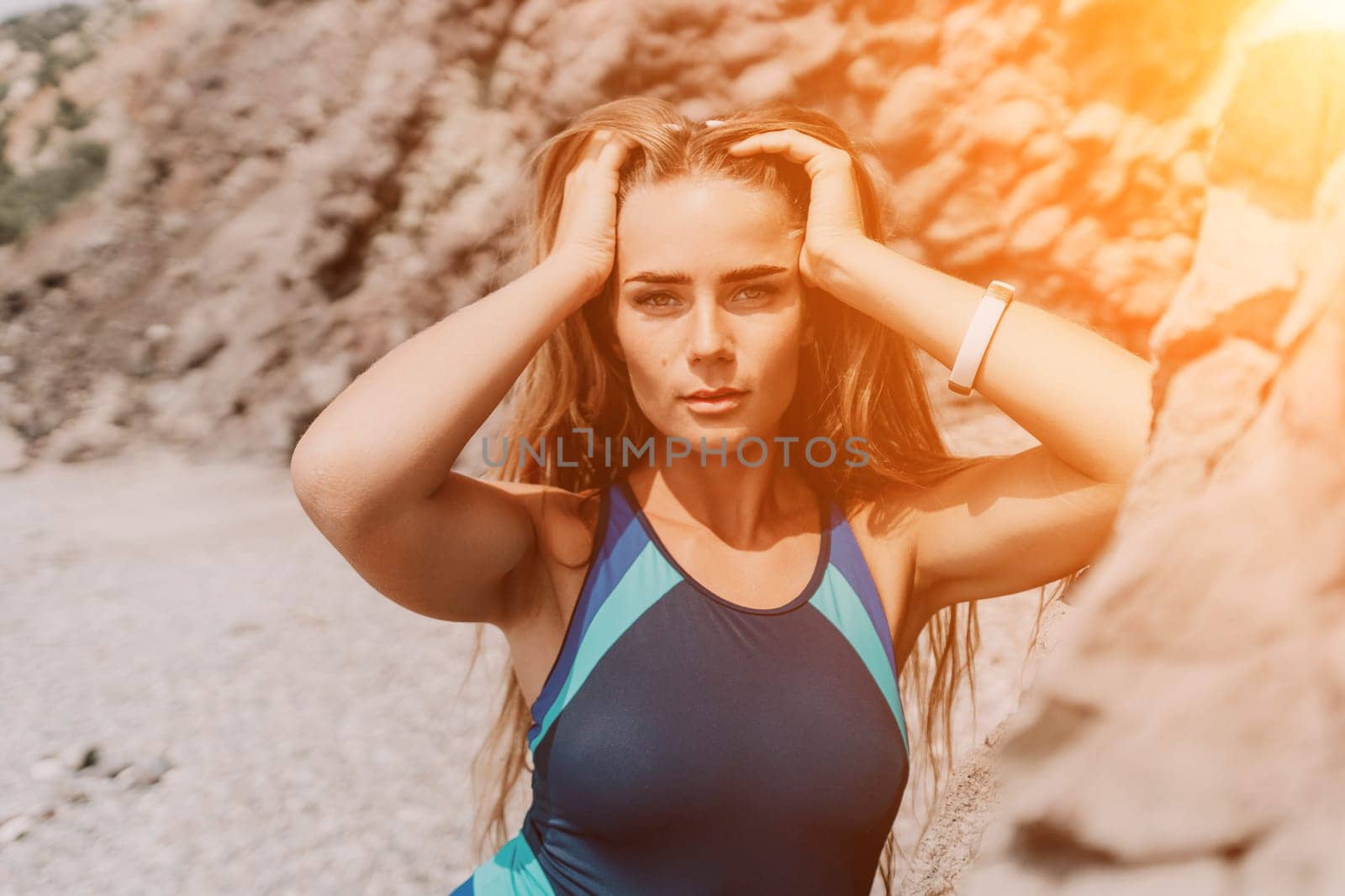 Woman travel sea. Young Happy woman in a long red dress posing on a beach near the sea on background of volcanic rocks, like in Iceland, sharing travel adventure journey