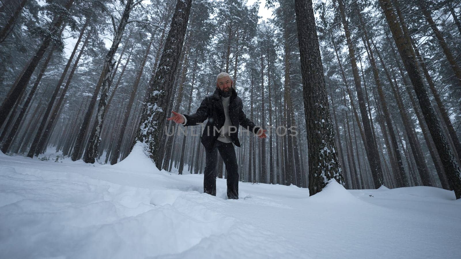 Man dancing in winter forest. Media. Stylish man is rapping in winter forest. Shooting music video with rapper in winter forest.