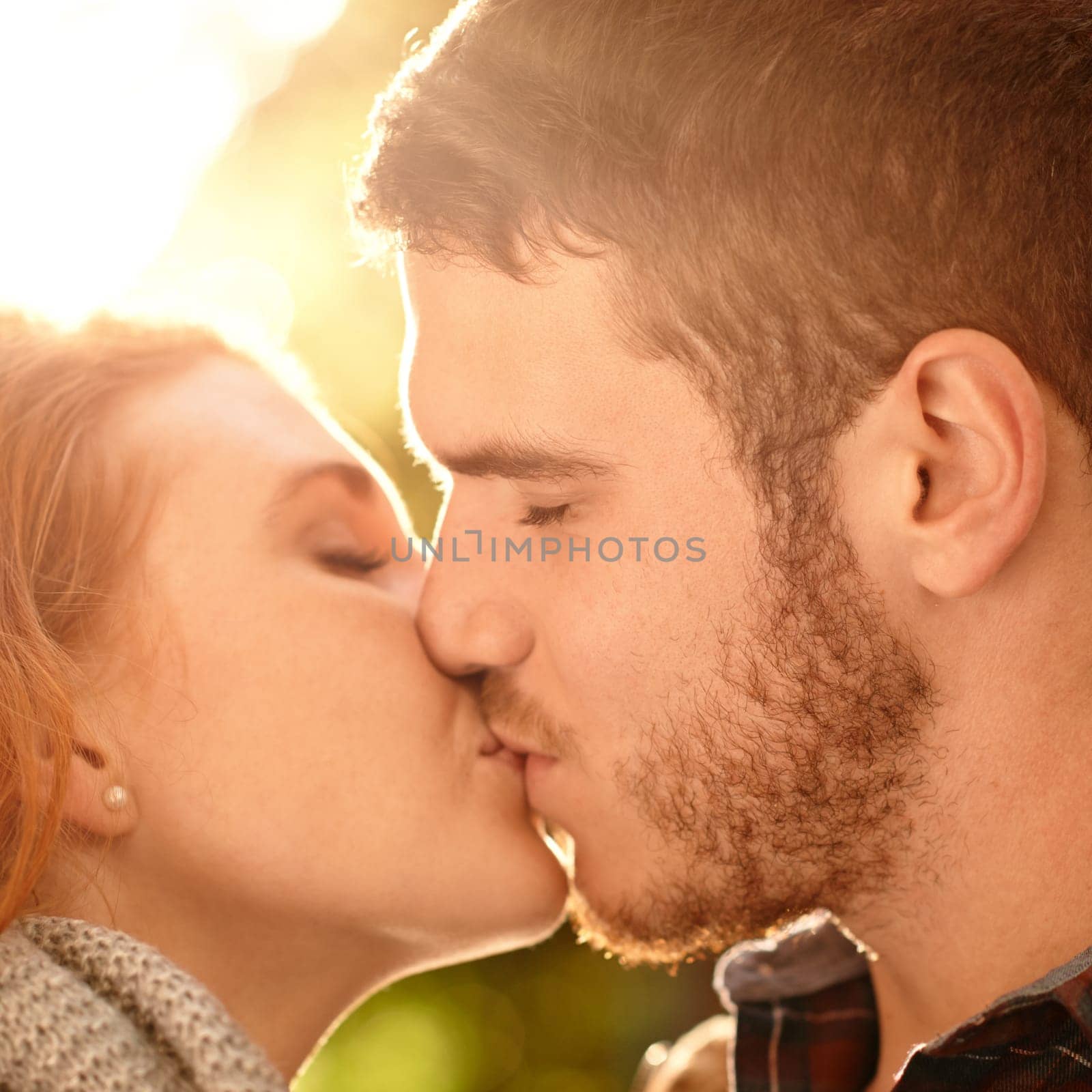 Couple, kiss and date closeup with love in park nature on holiday adventure or relax on vacation in woods. Together, man and woman with support and care in marriage and travel forest in morning by YuriArcurs