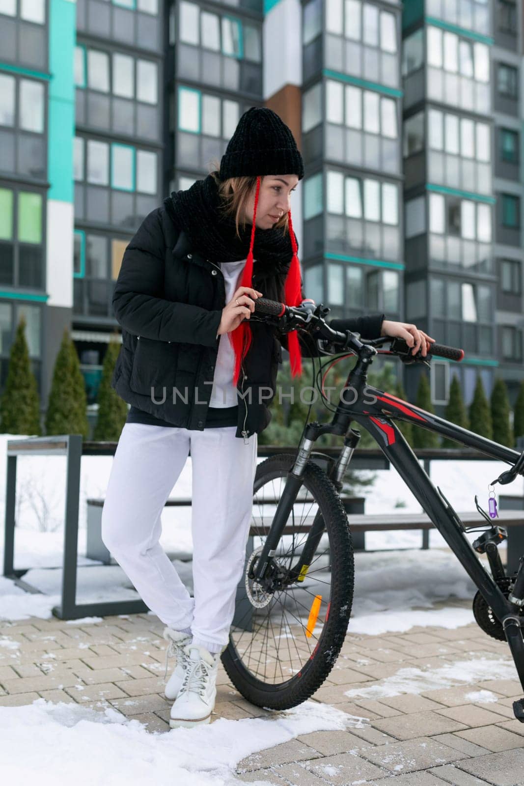 Lifestyle concept, Caucasian woman frolicking while riding a bicycle in winter.