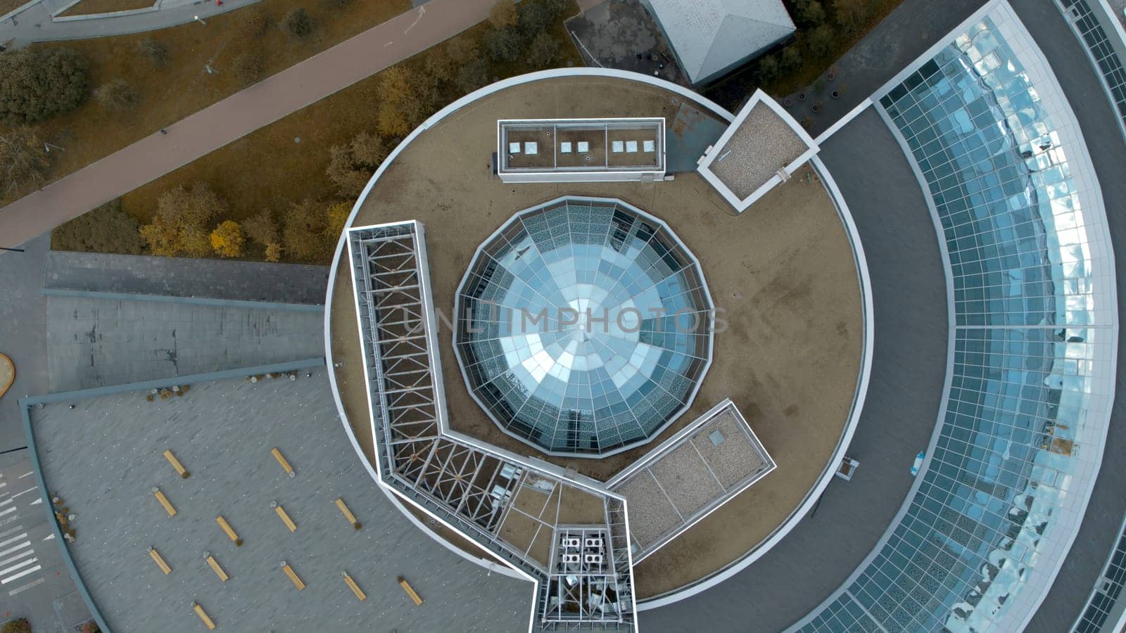 Top view of modern round building with dome. Stock footage. Beautiful architecture of business center with round structure and dome. Rings of building with beautiful facade.