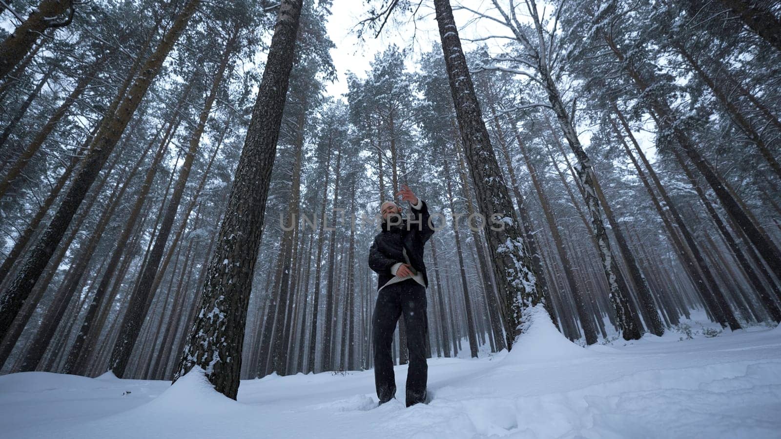Shooting clip in winter forest. Media. Stylish man is rapping in winter forest. Man moves stylishly and raps in winter forest. Music video by Mediawhalestock