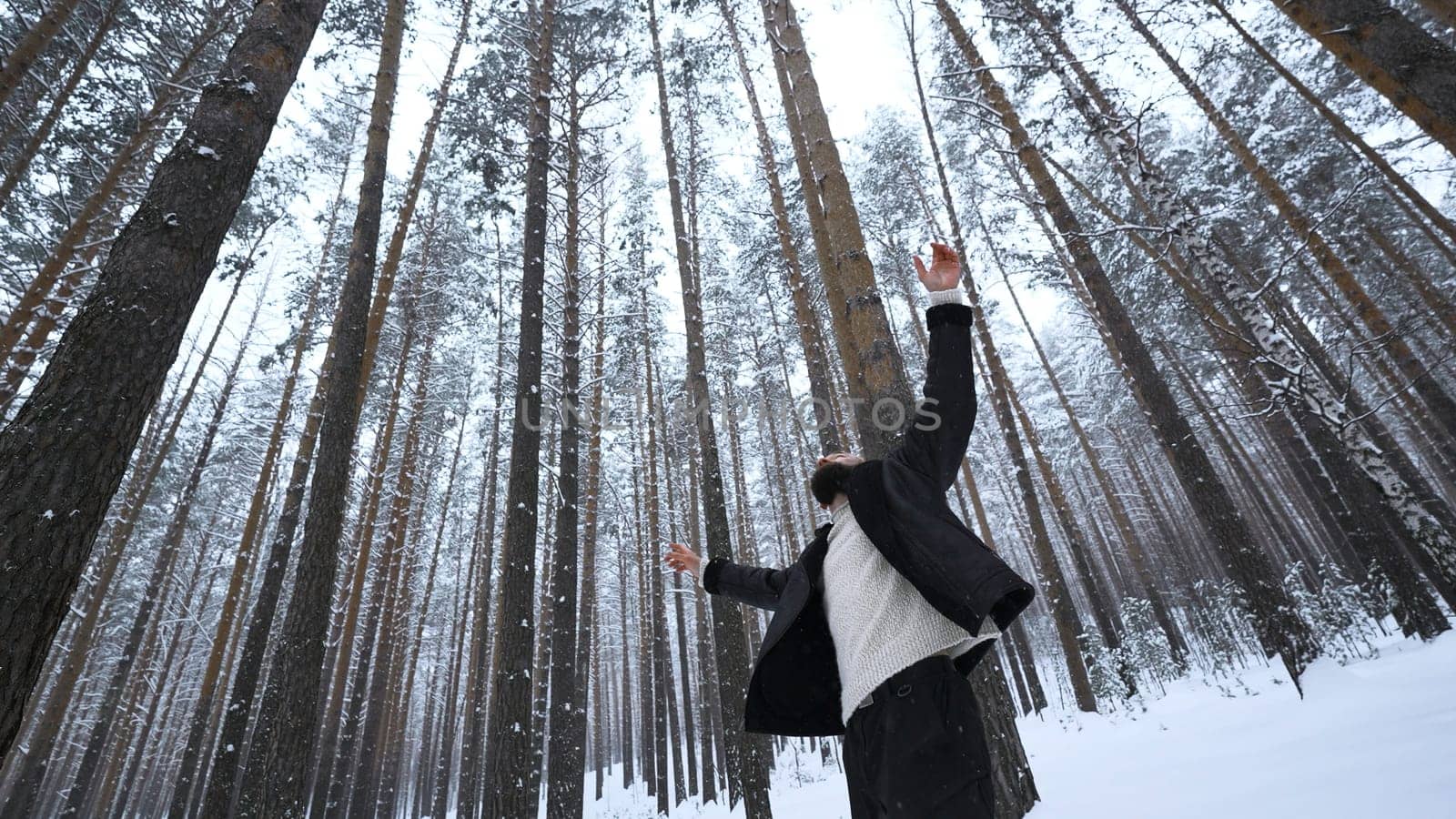 Man dancing in winter forest. Media. Stylish man filming video clip in winter forest. Shooting stylish man in winter forest.