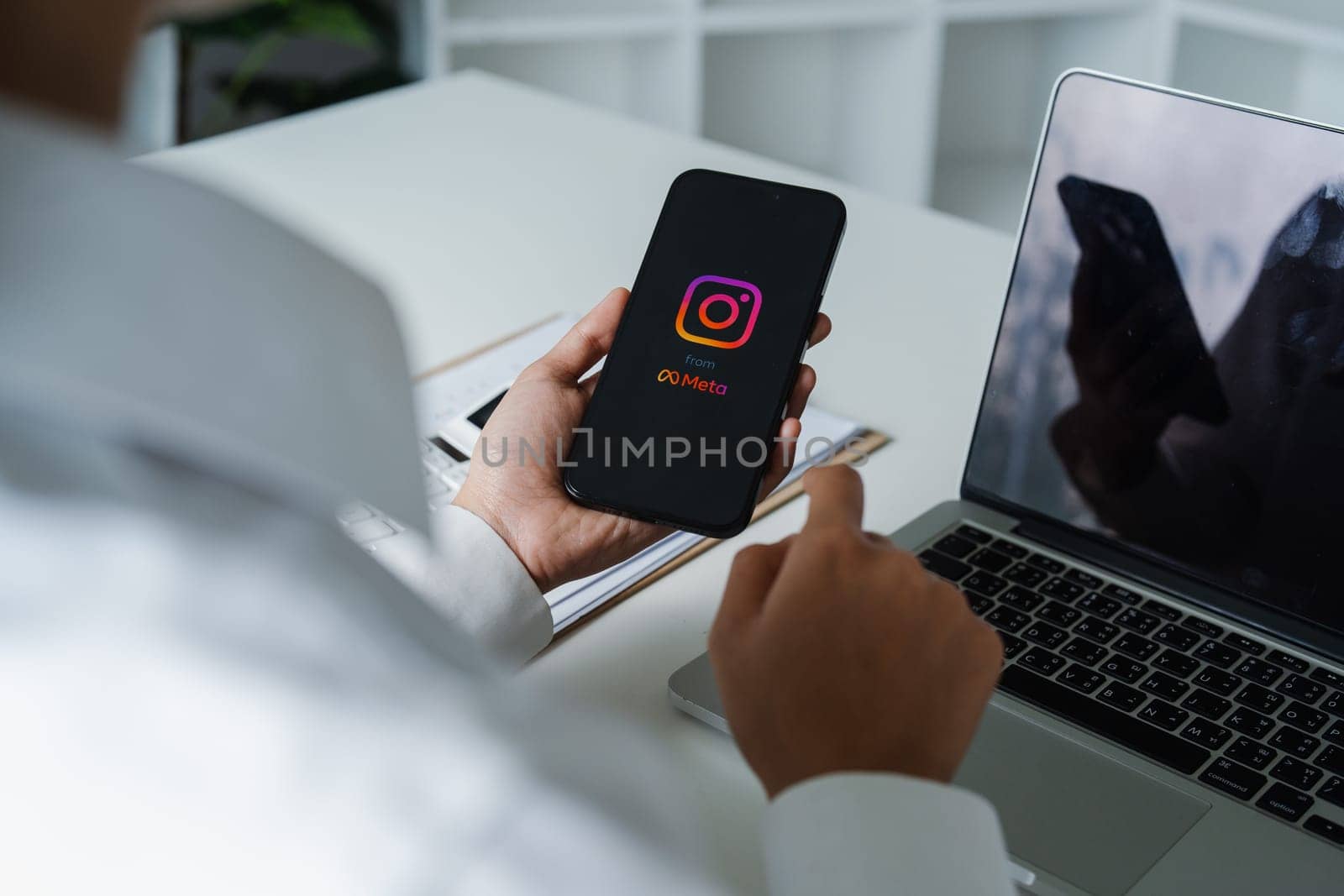 CHIANG MAI, THAILAND - March 20,2024: A woman holds Apple iPhone with Instagram application on the screen. Instagram is a photo-sharing app for smartphones.