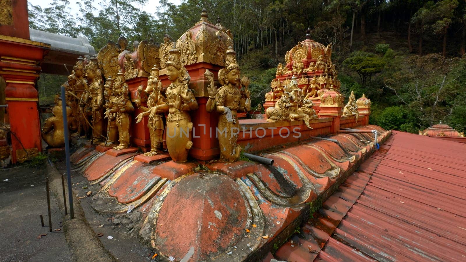Malaysian temple with golden statues of the saints. Action. Concept of religion and culture