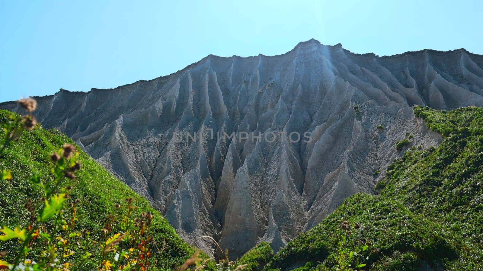 Beautiful white rocks with erosion and vegetation. Clip. Volcanic white rocks with erosion and amazing vegetation. Natural attraction with rocky landscape.