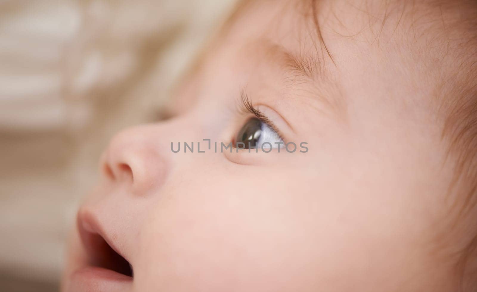 Newborn, closeup and baby with thinking for curiosity, childhood development and growth in bedroom. Adorable, healthy kid and cute infant with smile to relax, wonder or waking up in nursery at home.