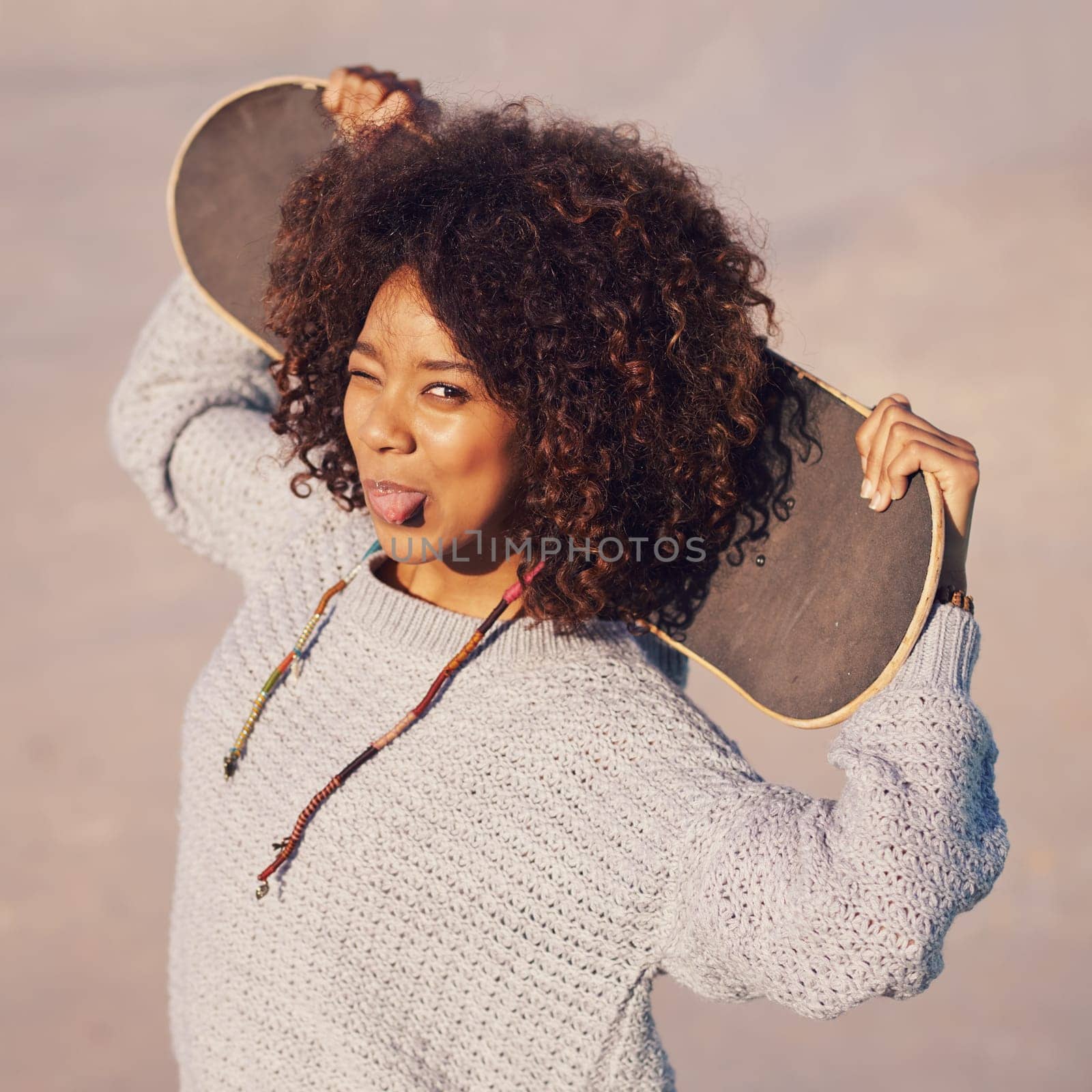 Portrait, funny and woman with skateboard in city in summer for sport, exercise or leisure outdoor. Tongue out, face and person wink at skate park in casual clothes for trendy fashion in South Africa.