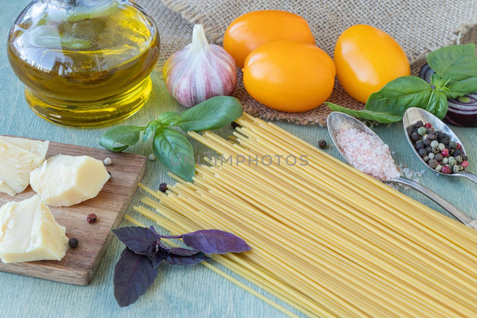 recipe for pasta with tomatoes or macaroni al pomodoro close-up of spaghetti, tomatoes, olive oil, basil, parmesan cheese, onion, garlic and spices. by Leoschka