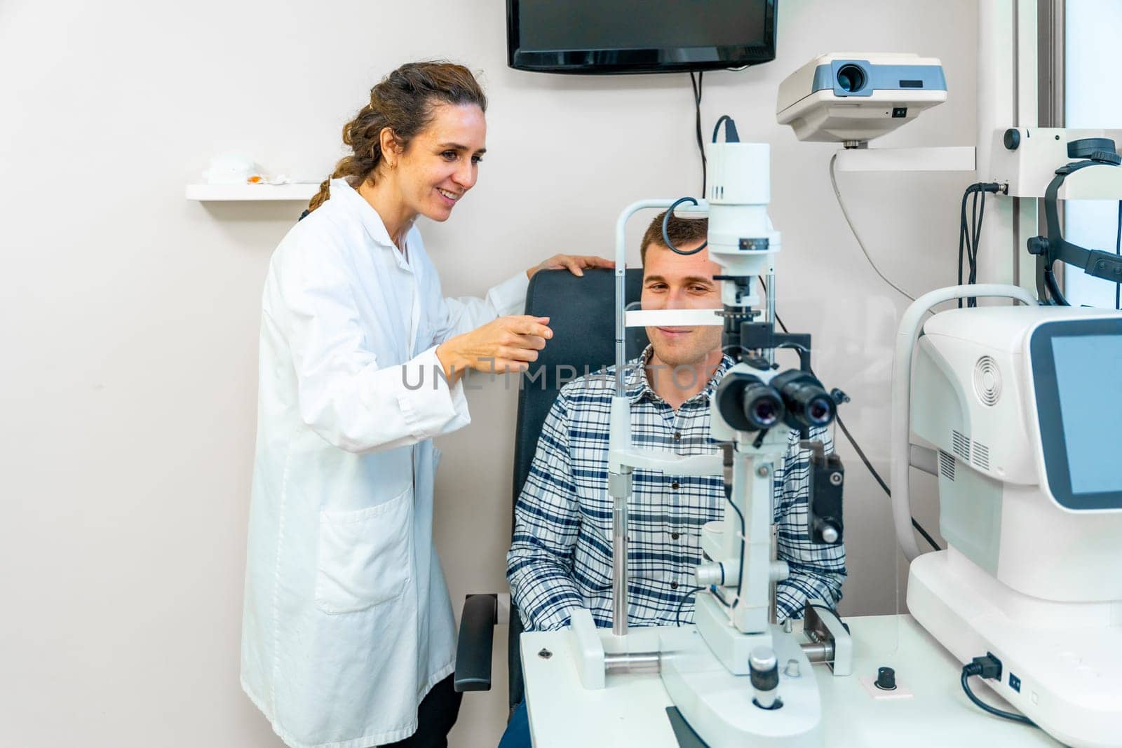 Man doing a routine checkup in an ophthalmologist by Huizi