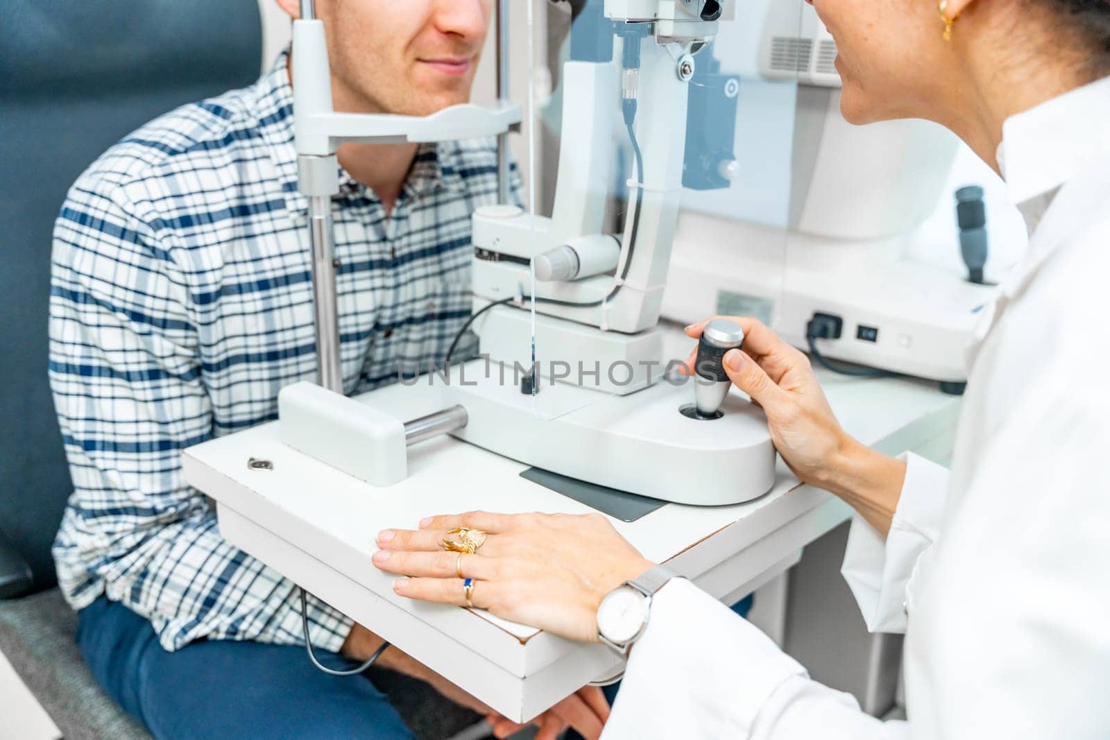 Man checking the eye vision in ophthalmology clinic by Huizi