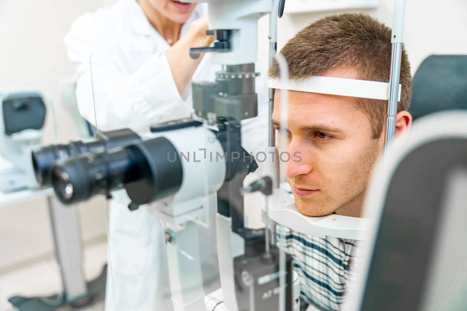 Man having his eyes checked at ophthalmologist by Huizi