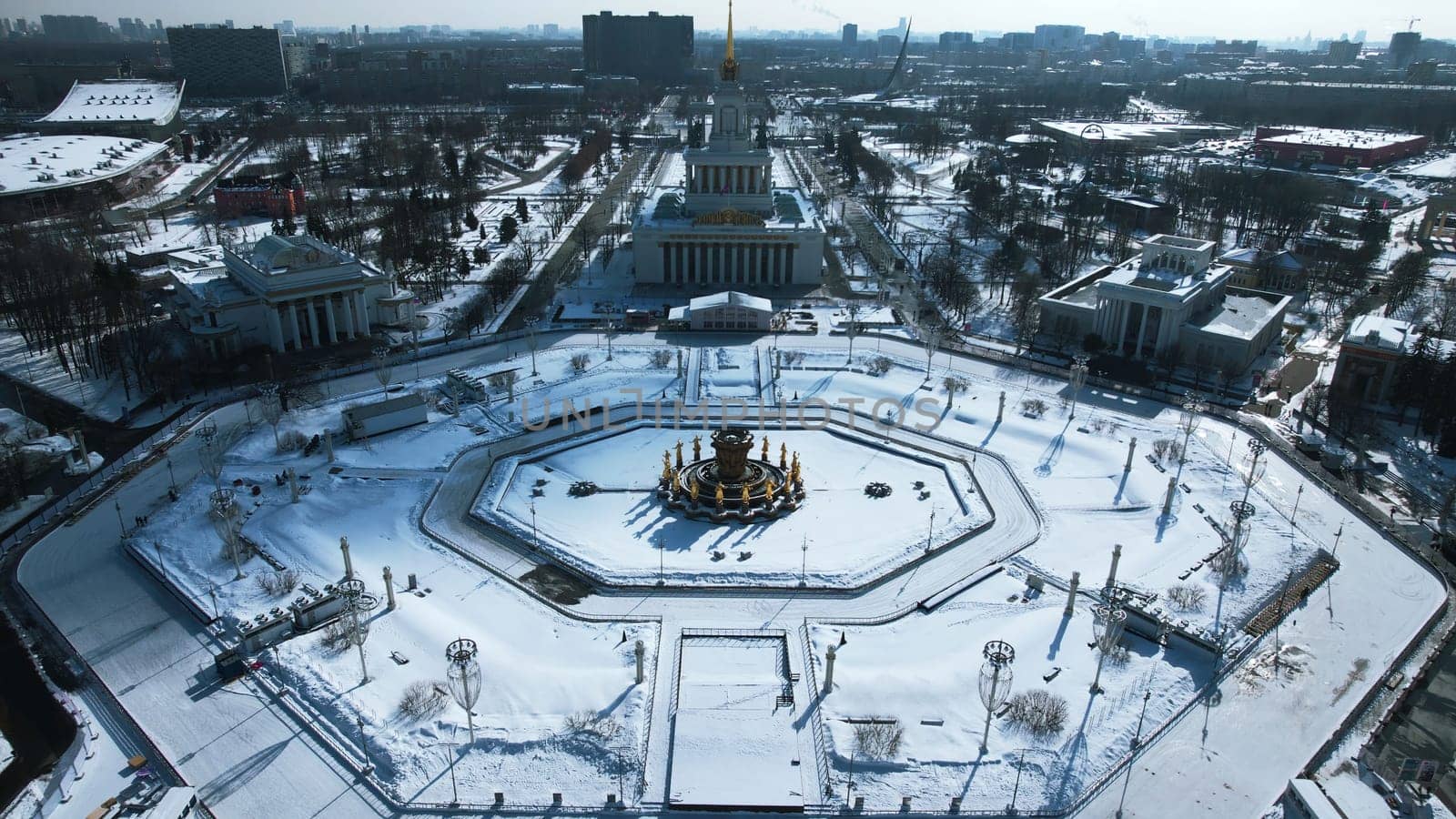 Top view of round square in winter. Creative. Beautiful historical square with fountain on sunny winter day. Sovetskaya Square with architecture and square in city center by Mediawhalestock