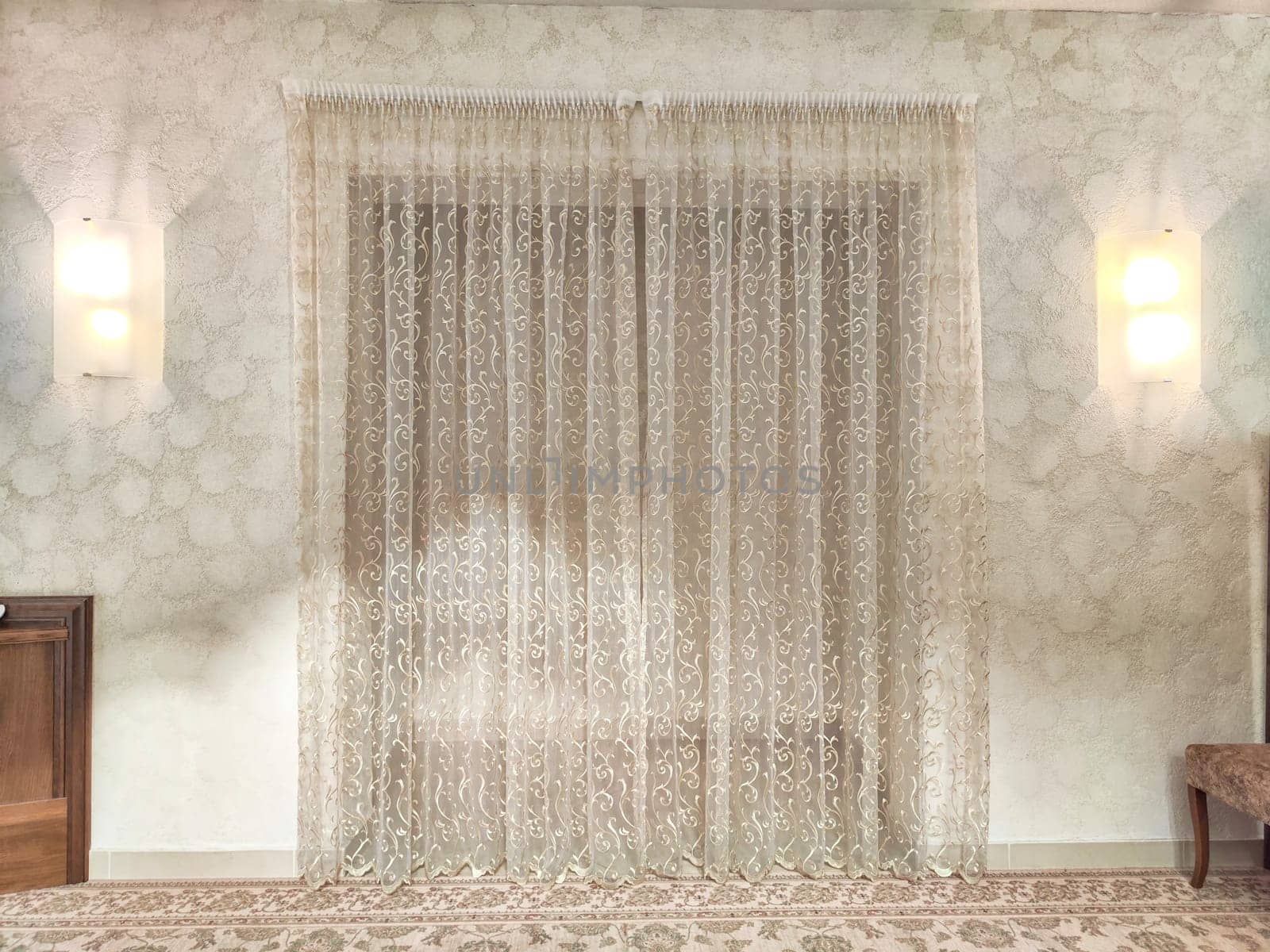 Transparent white curtain on entrance in home interior. Curtain background on the door