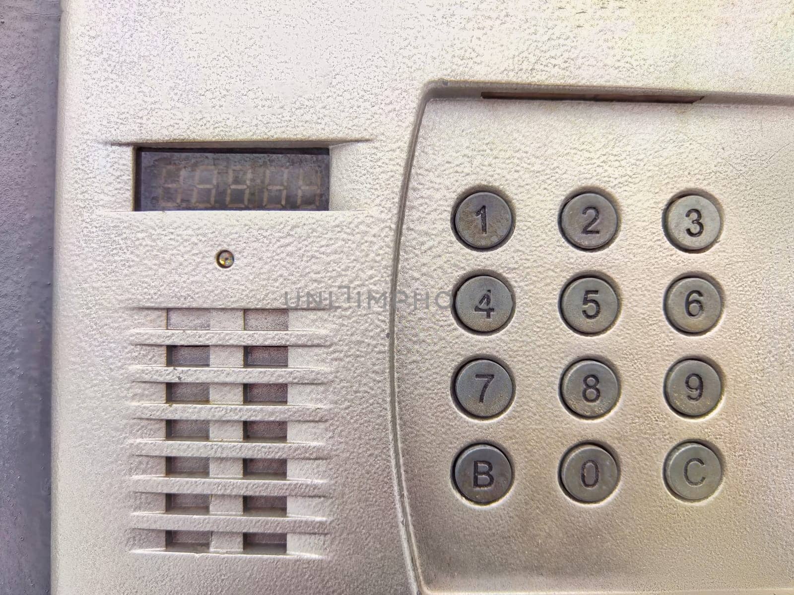 A detailed look at a wall intercom with a keypad for secure access