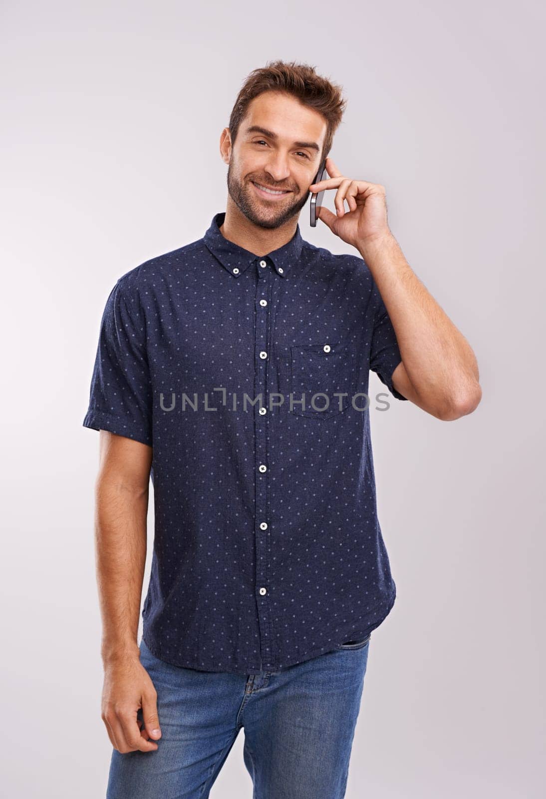 Networking, man and portrait of phone call with communication in studio, background and mockup. Happy, businessman and contact on smartphone with news, feedback of information or announcement in chat.