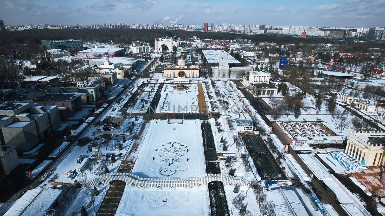 Top view of large square with historical architecture in winter. Creative. Historic square with alleys and Soviet architecture in city center. Winter landscape with Soviet architecture on background of horizon with city.