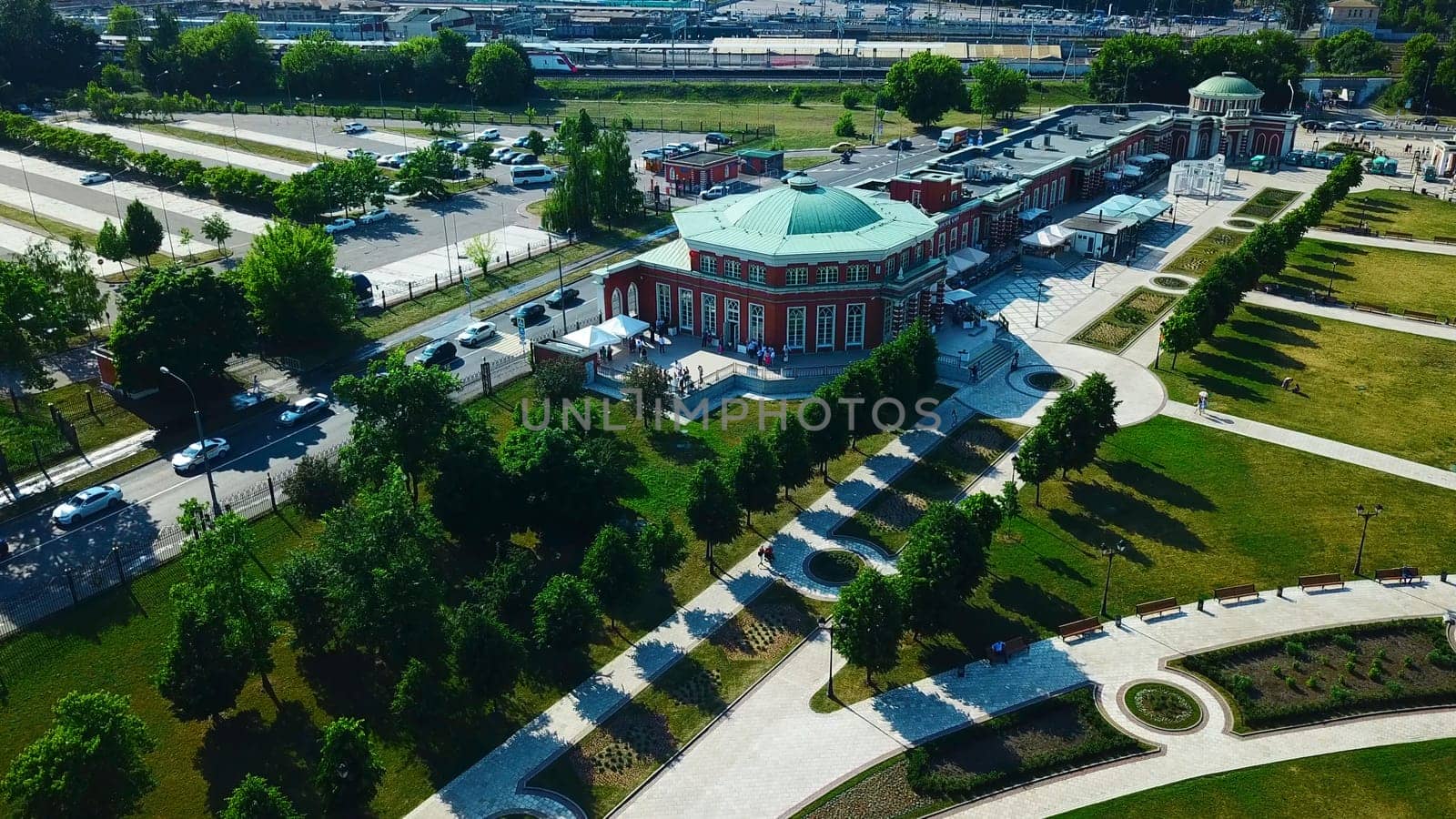 Top view of historic building with garden patterns on sunny day. Creative. Landscape design of garden with patterns near historic building. Historical complex with garden on background of modern city.