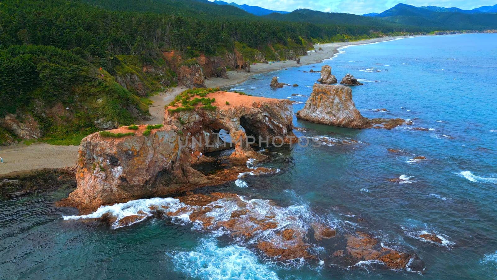 Top view of amazing cliffs of sea coast. Clip. Rocks with erosion of sea waves create amazing stone arches. Beautiful rocky arches on seashore.