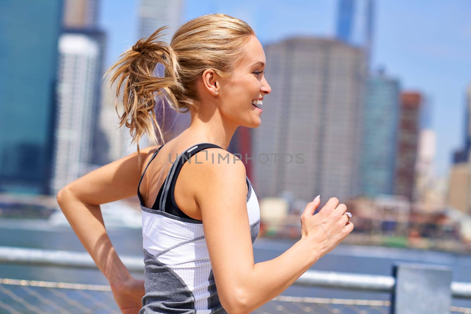 Woman, excited and running for fitness in city, jogging active and fit female person exercising in New York. Energy, marathon for sports training and workout for athlete, cardio wellness or endurance by YuriArcurs