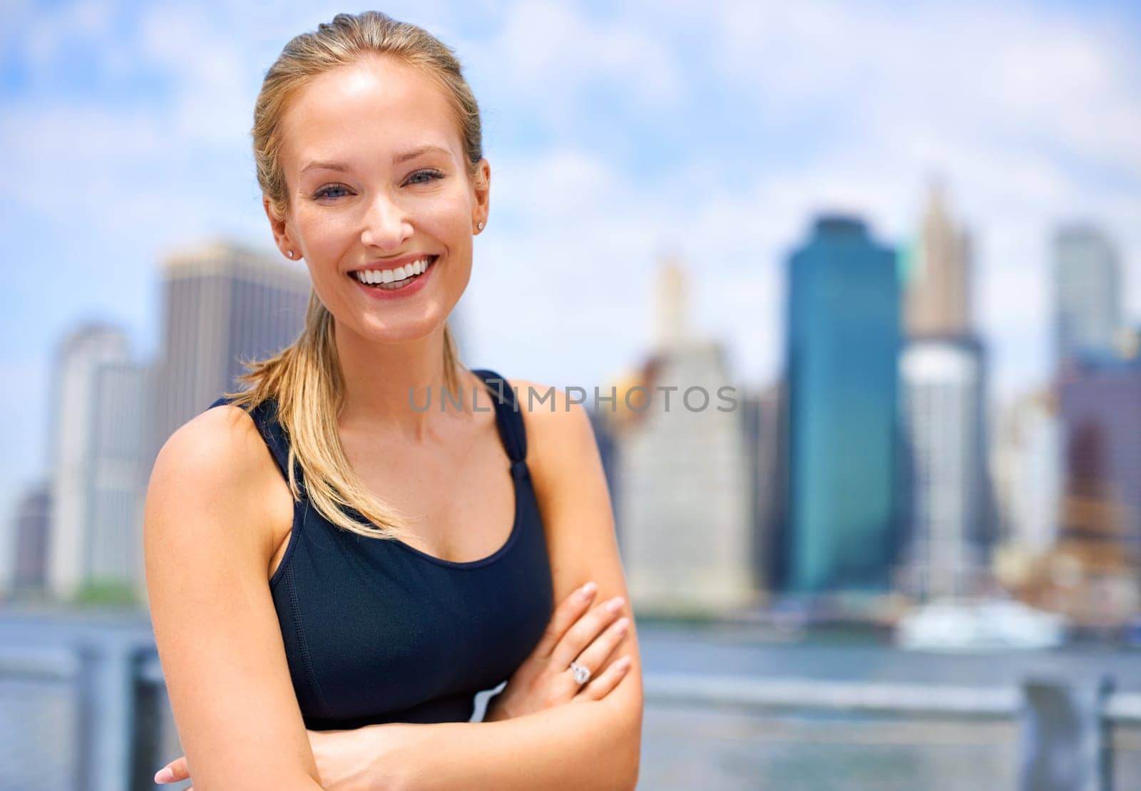 Workout, portrait and woman with arms crossed for fitness, morning exercise or running competition in city. Smile, wellness and face of female person for cardio, energy and confidence in New York.