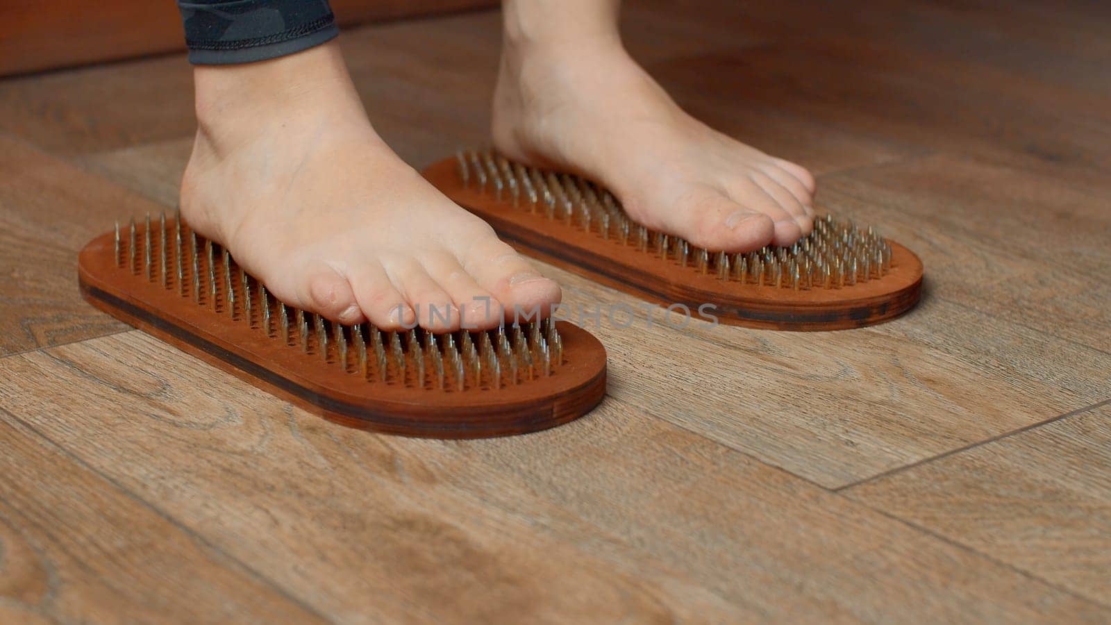 Close up view f woman standing on nails. Media. Practice of standing on nails, concept of feelings breakthrough