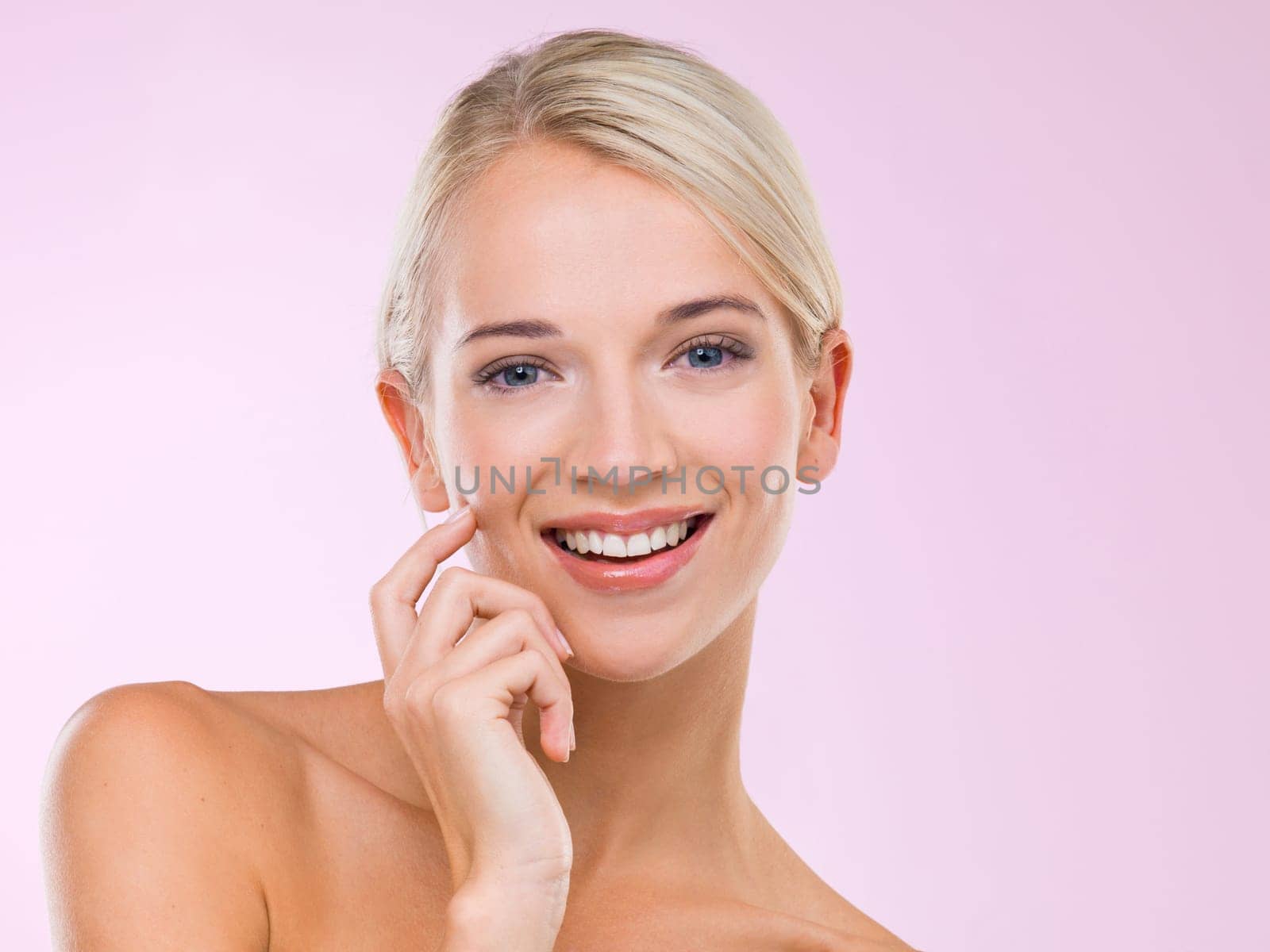 Woman, portrait and skincare beauty in studio for healthy treatment, pink background or confidence. Female person, face and hand for makeup cosmetics or dermatology wellness, facial or mockup space.
