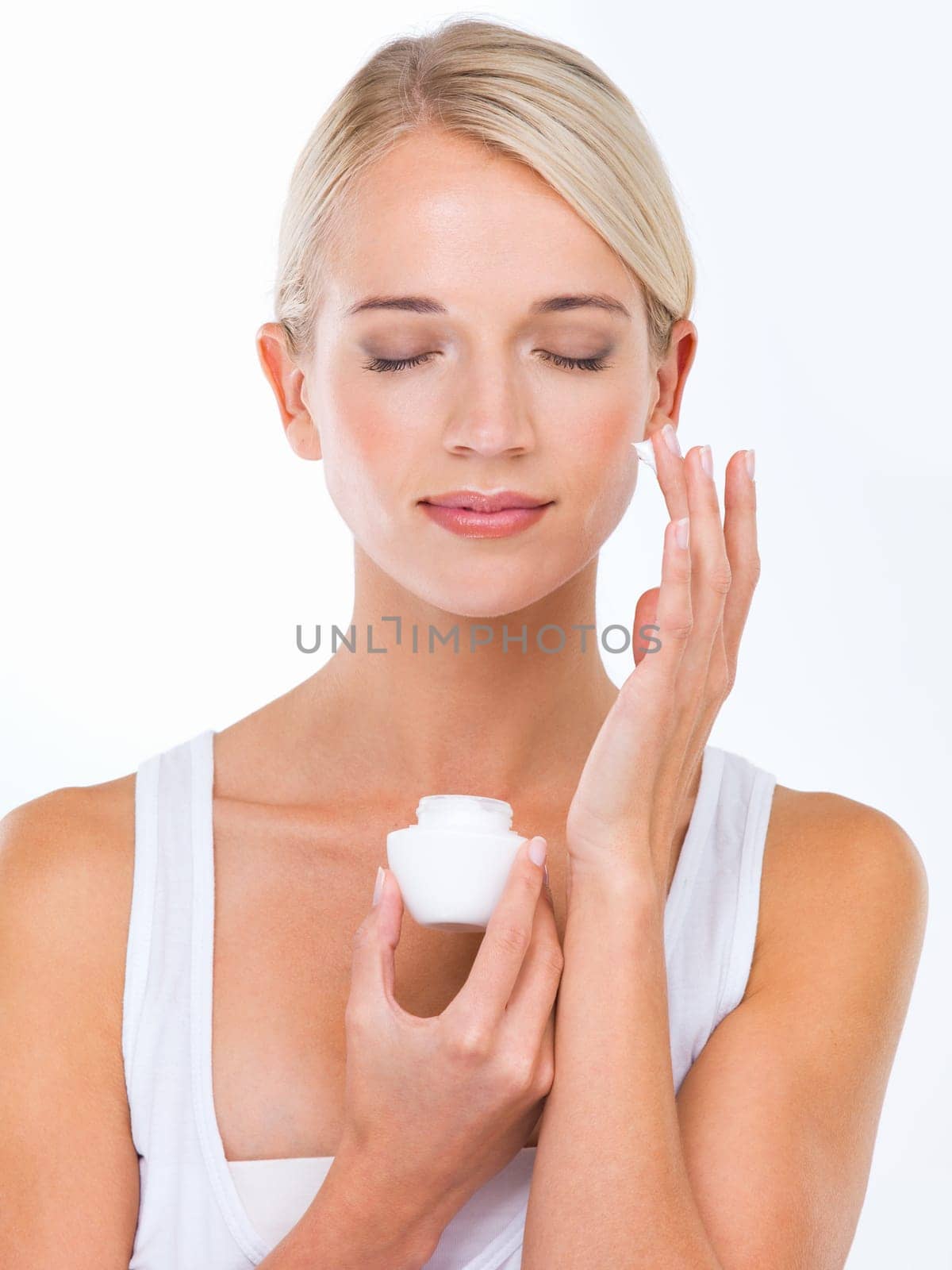 Woman, hand and moisturizer cream or skincare dermatology or healthy treatment, studio or white background. female person, product and sunscreen protection or face lotion, benefits or mockup space by YuriArcurs