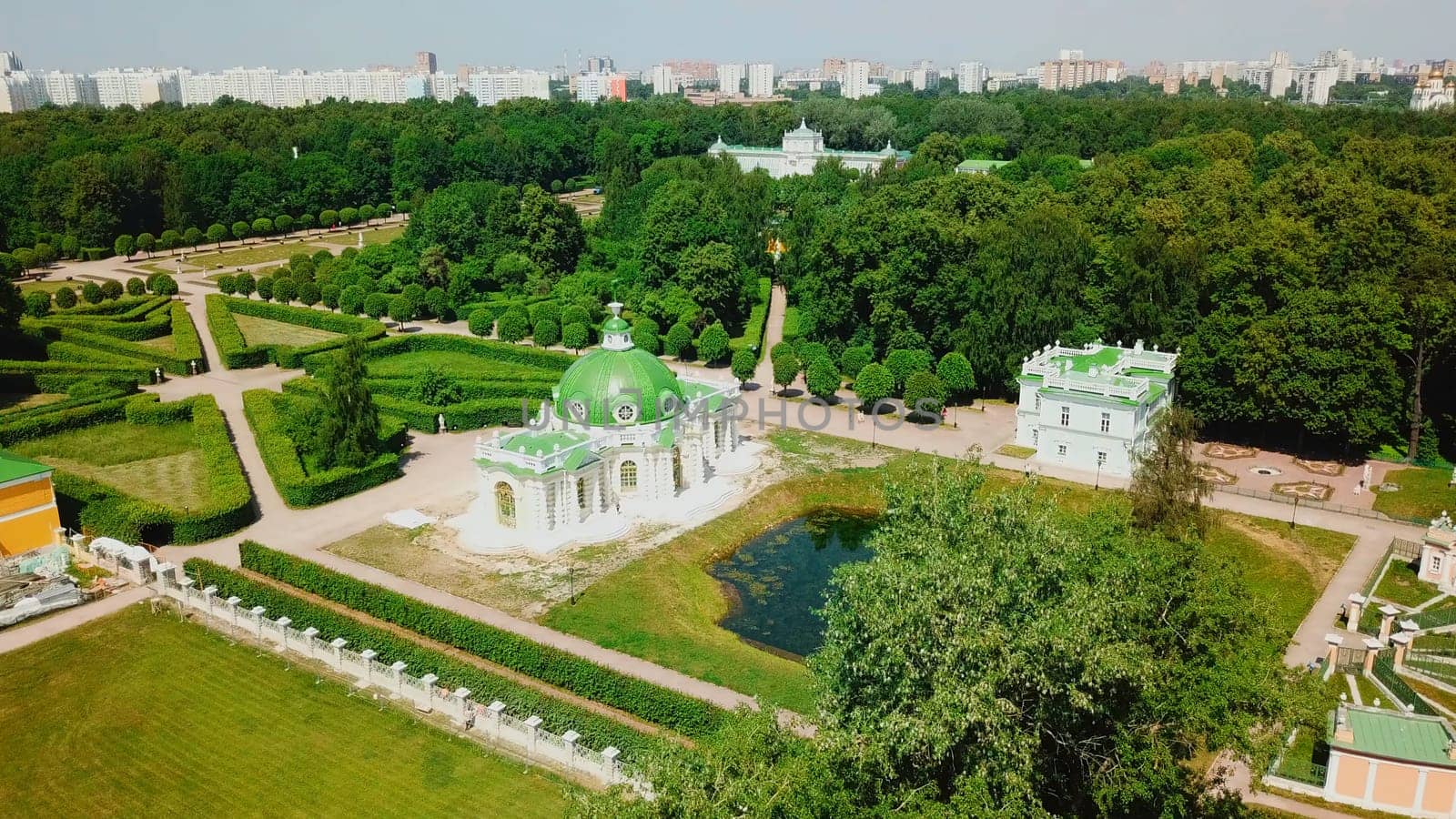 Top view of palace complex with park and pond. Creative. Landscape of palace grounds with park and pond. Beautiful summer park with green landscapes and palace buildings.