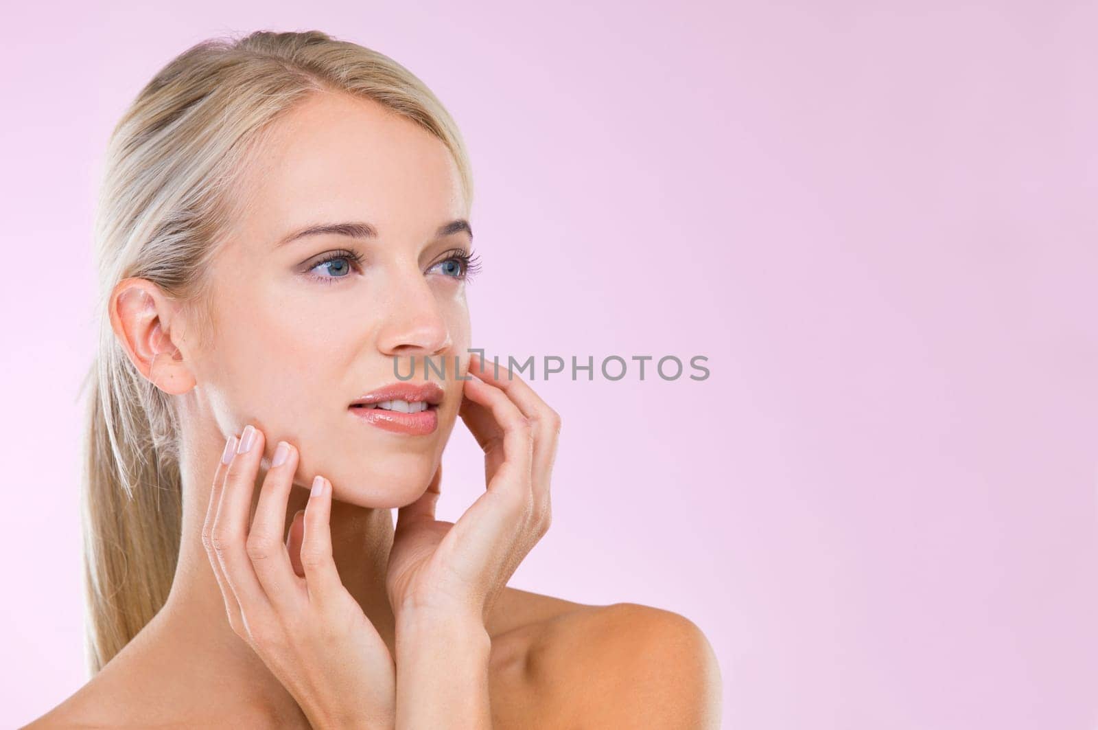 Woman, skincare and beauty in studio with space, results and hands of face with natural glow by pink background. Girl, person and model with cosmetics, mock up and facial transformation with thinking.